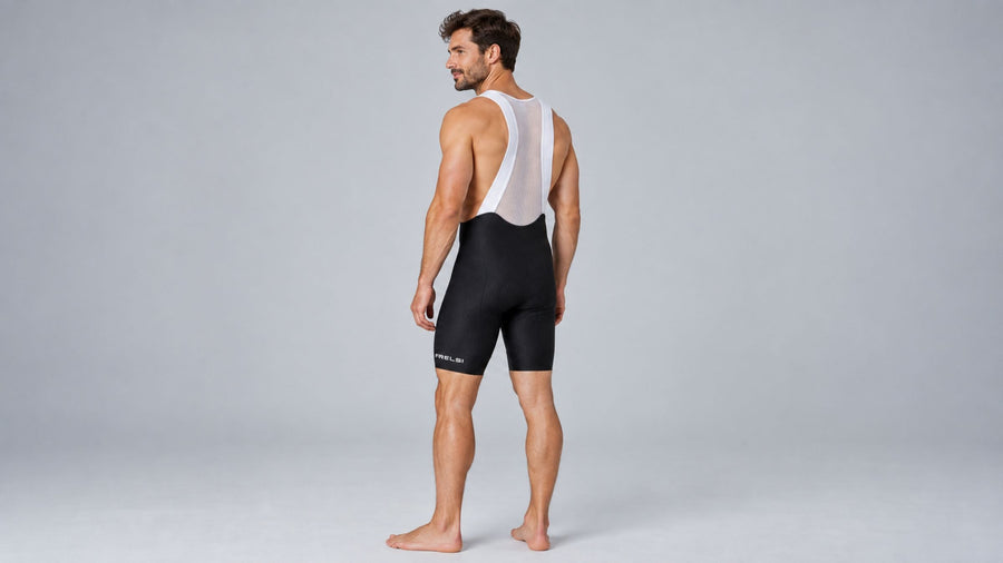 Rear view of a man in black Frelsi Pro Team Bib Shorts showing the straps, seams and leg grippers