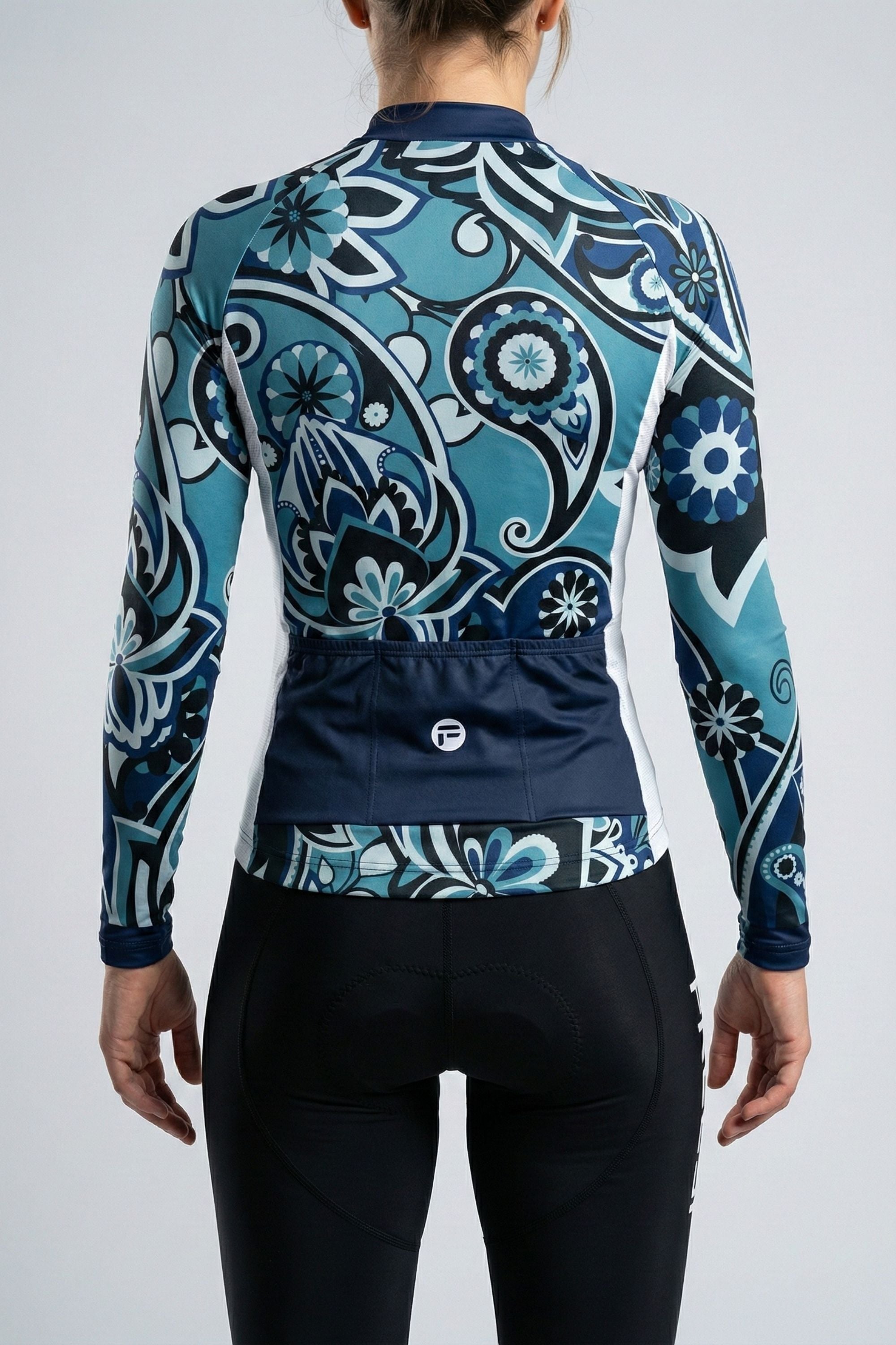 Person wearing a blue cycling outfit on a plain background by Cycling Frelsi