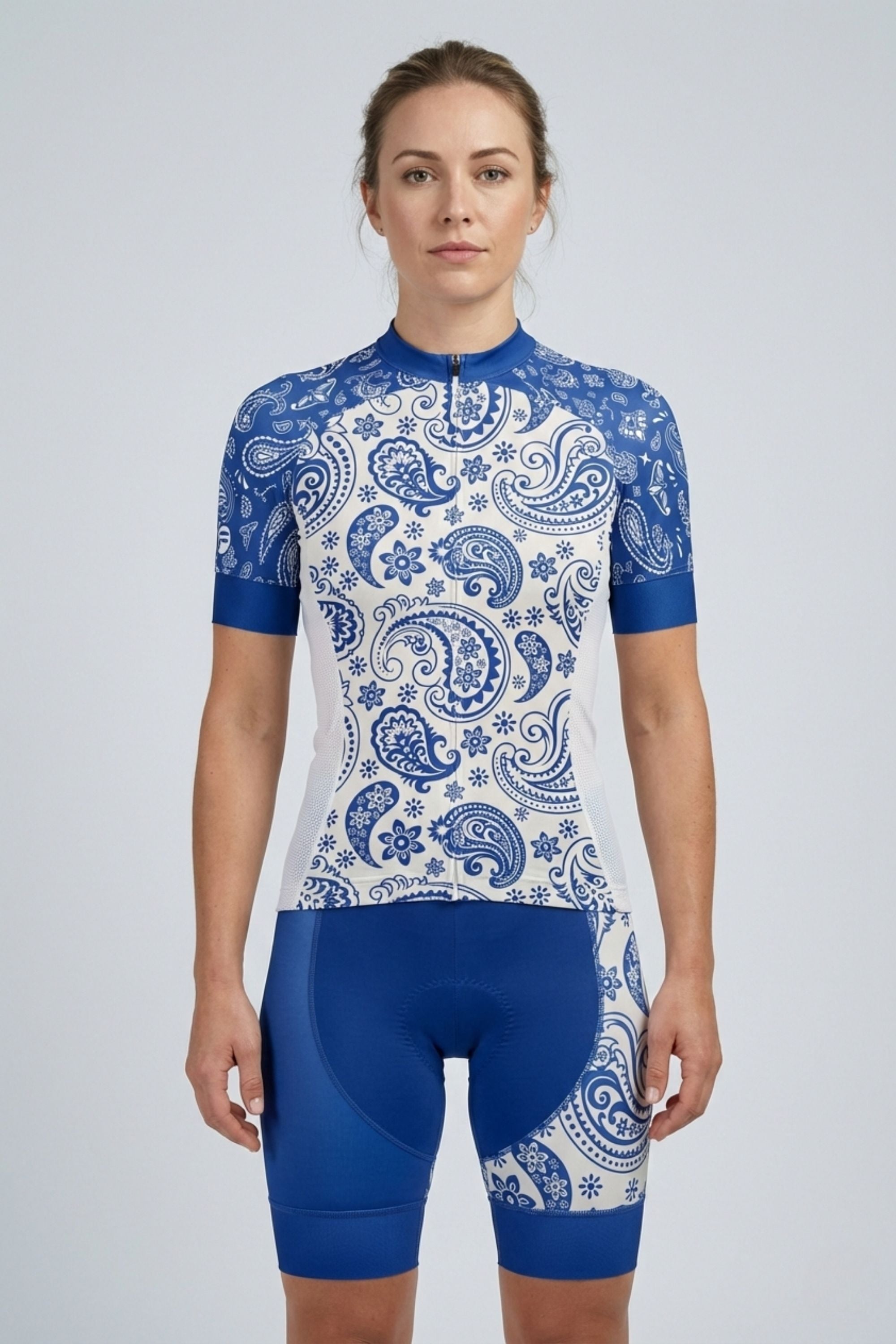 Woman wearing a blue and white patterned cycling outfit on a gray background - Blue Serenity | Women's Short Sleeve Cycling Set by Cycling Frelsi