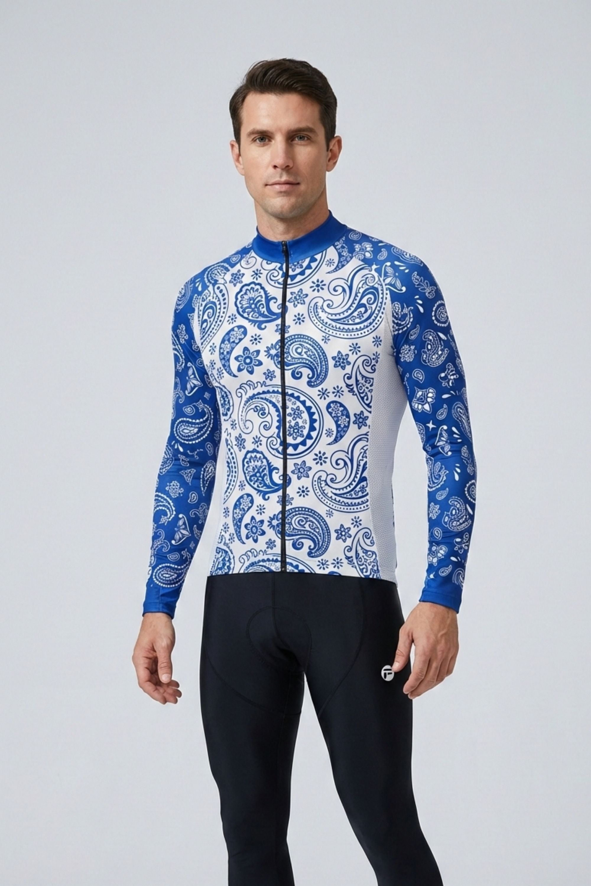 Man wearing a blue and white patterned cycling jersey on a gray background