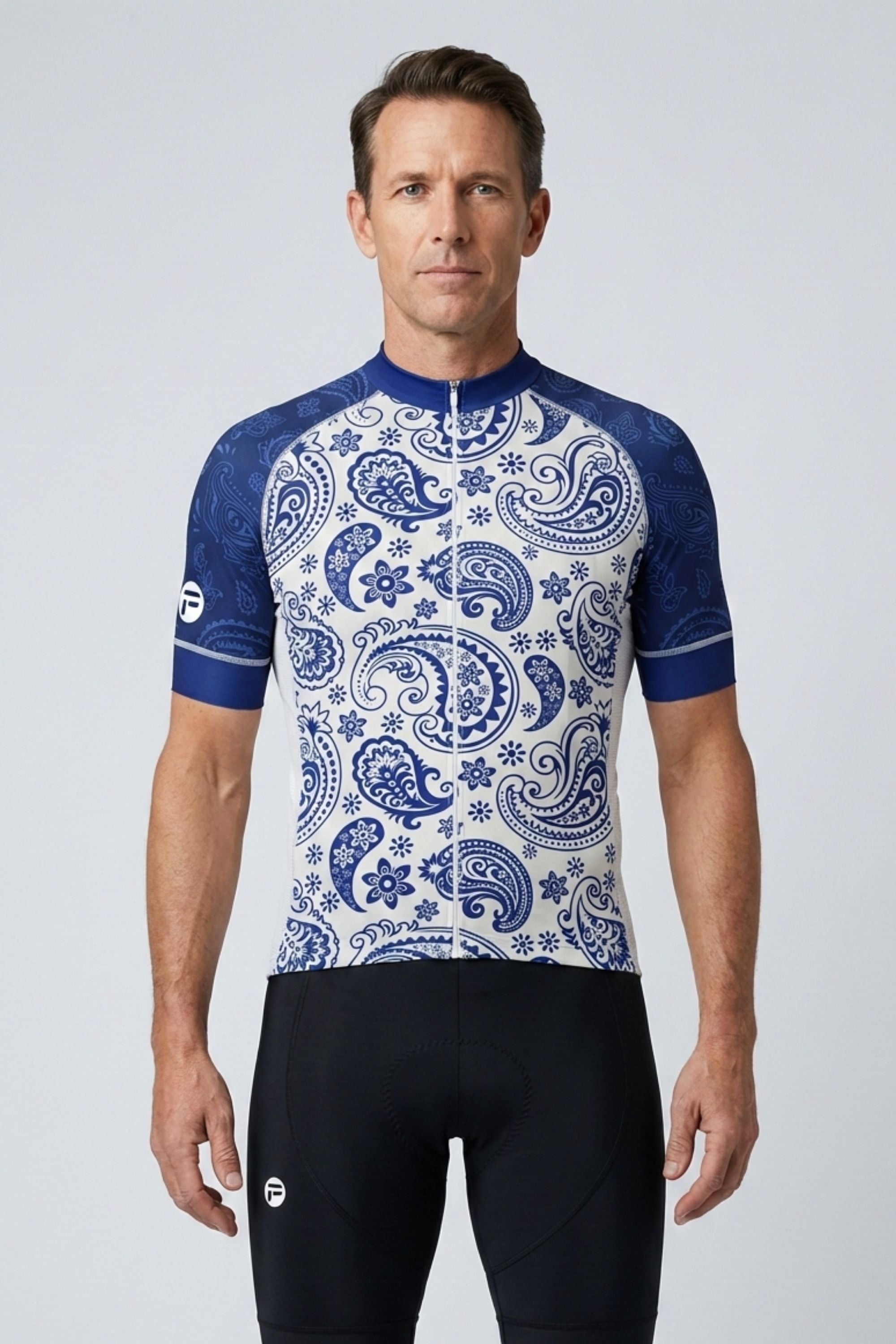 Man wearing a blue and white patterned cycling jersey on a light gray background