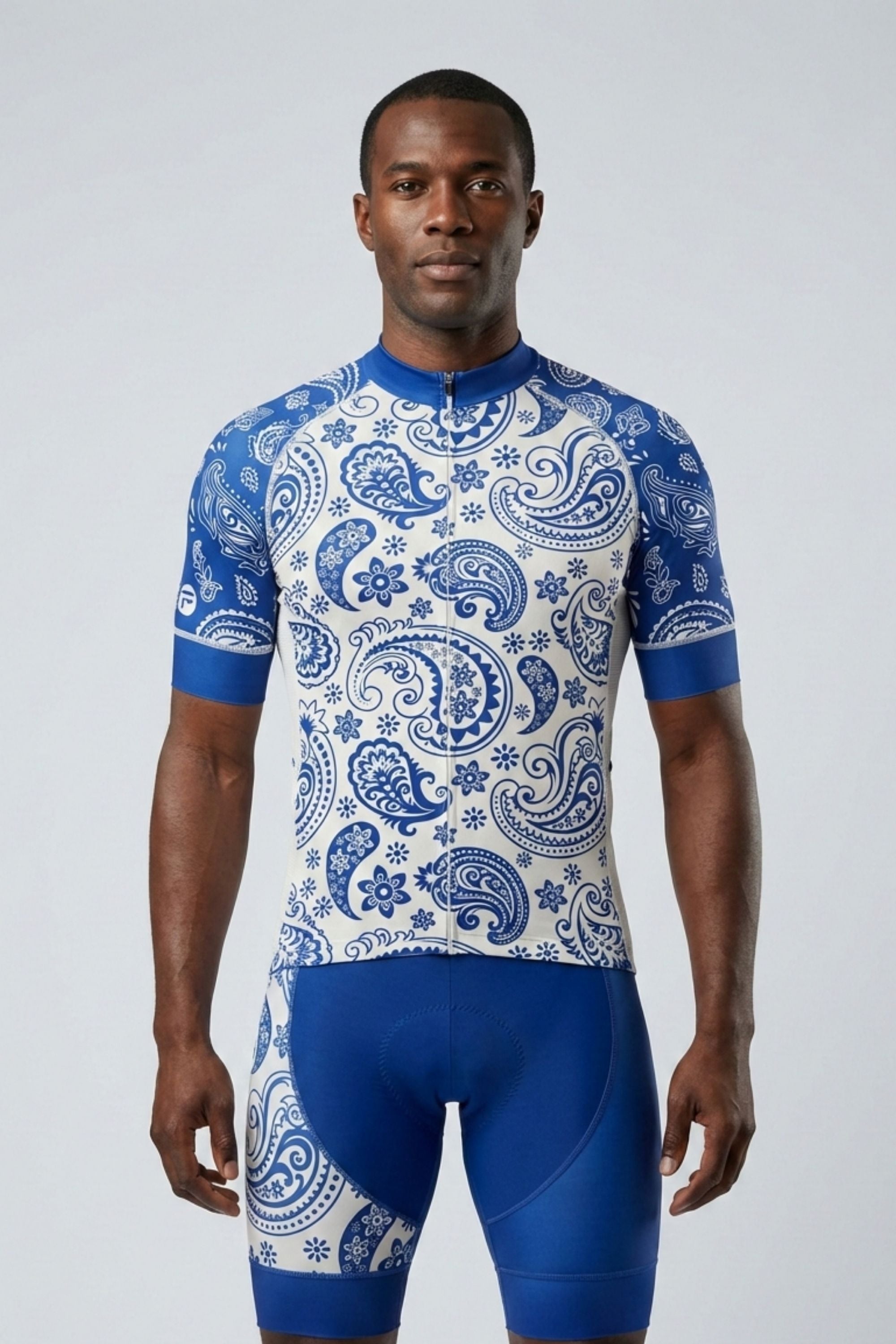 Person wearing a blue and white patterned cycling outfit on a plain background