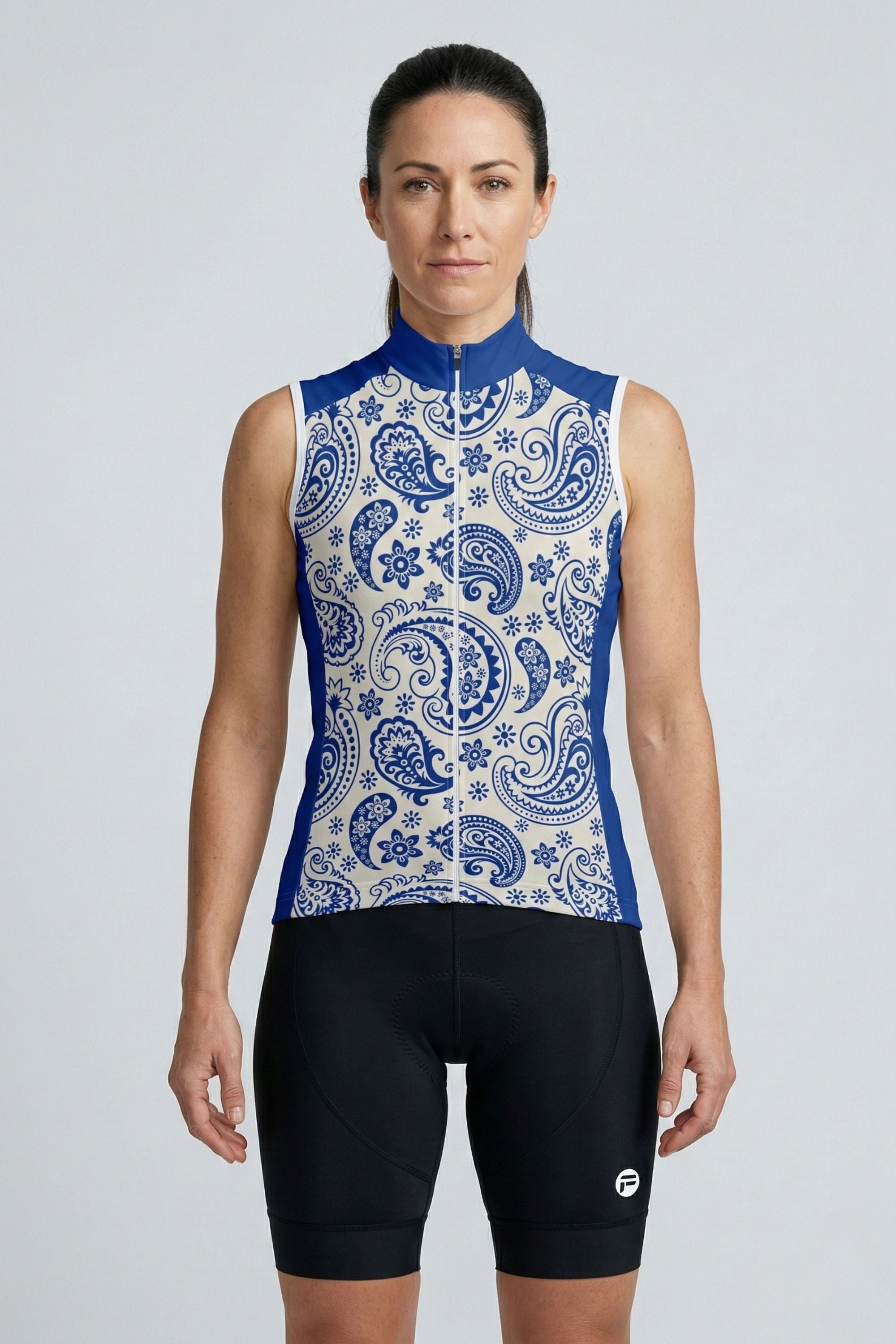 Woman wearing a sleeveless cycling jersey with a blue and white paisley pattern on a gray background