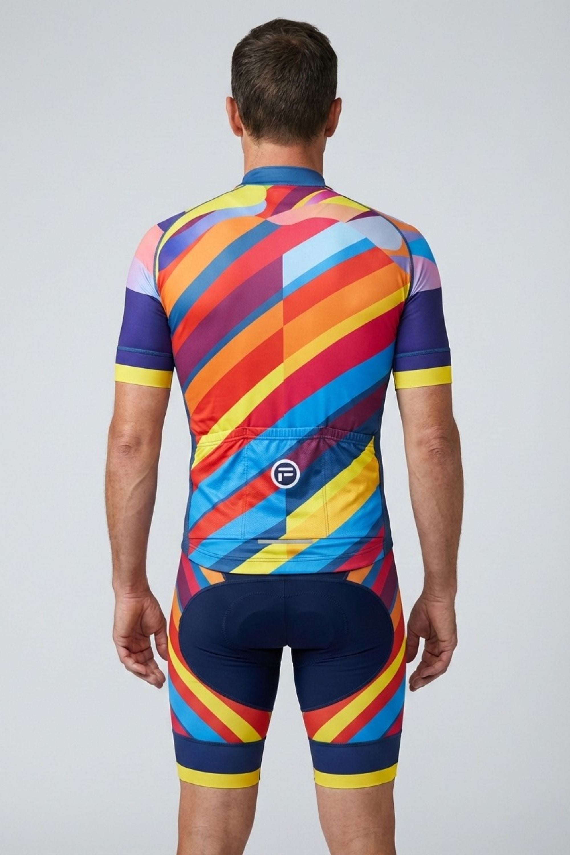 Person wearing a colorful cycling suit with a geometric pattern on a plain background