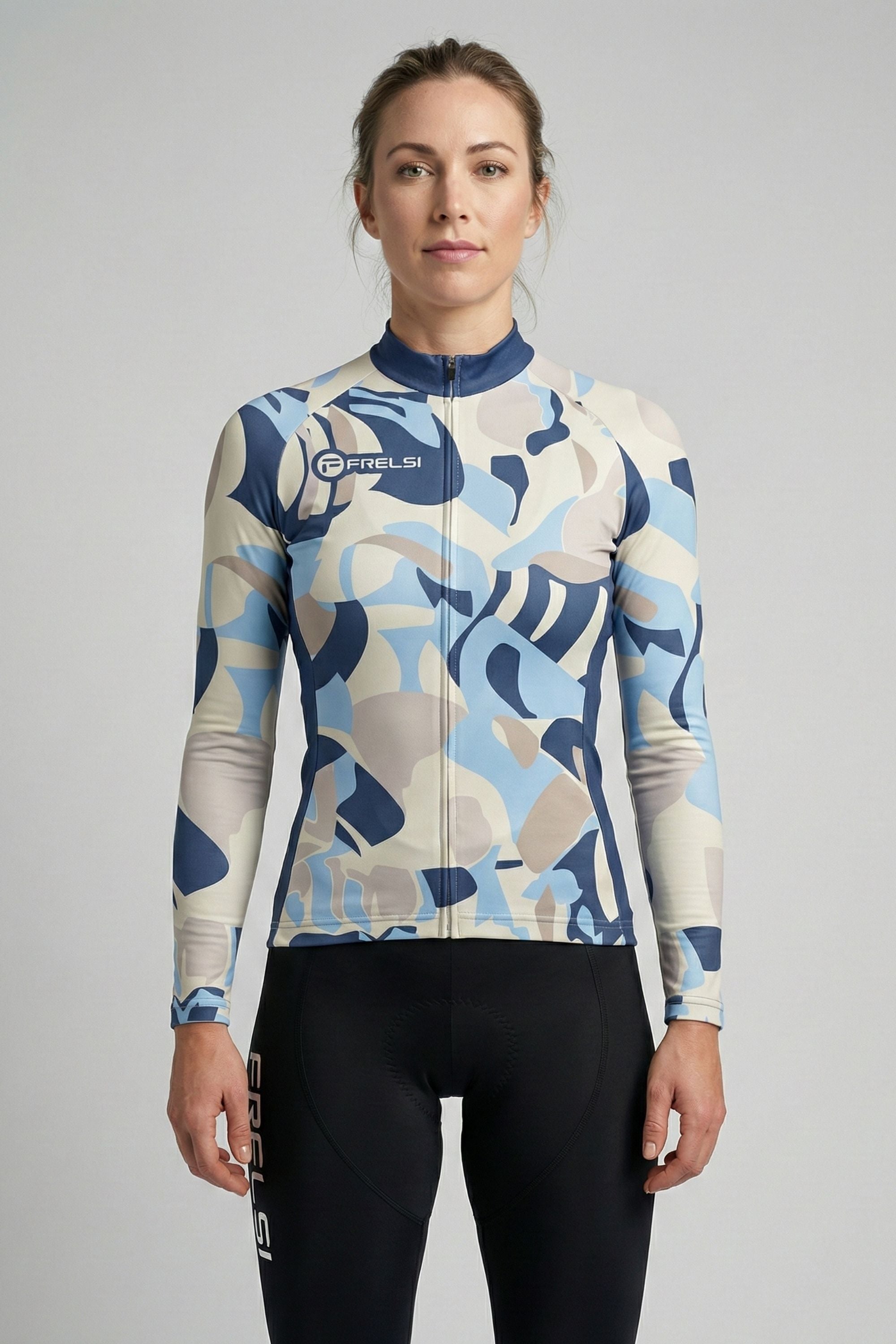 Person wearing a white cycling outfit with blue and yellow stripes on a plain background by Cycling Frelsi