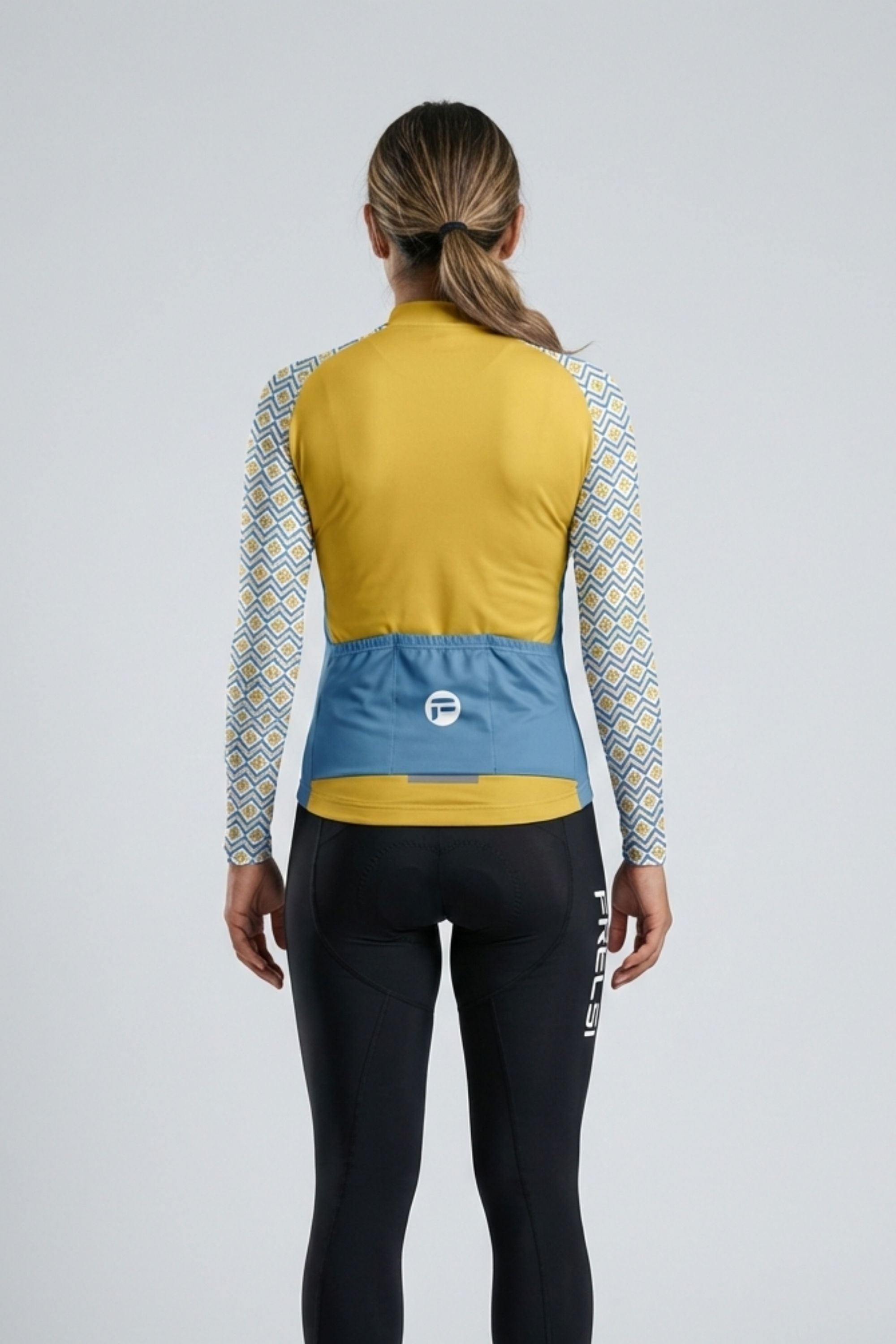 Person wearing a yellow and white cycling outfit on a plain background by Cycling Frelsi