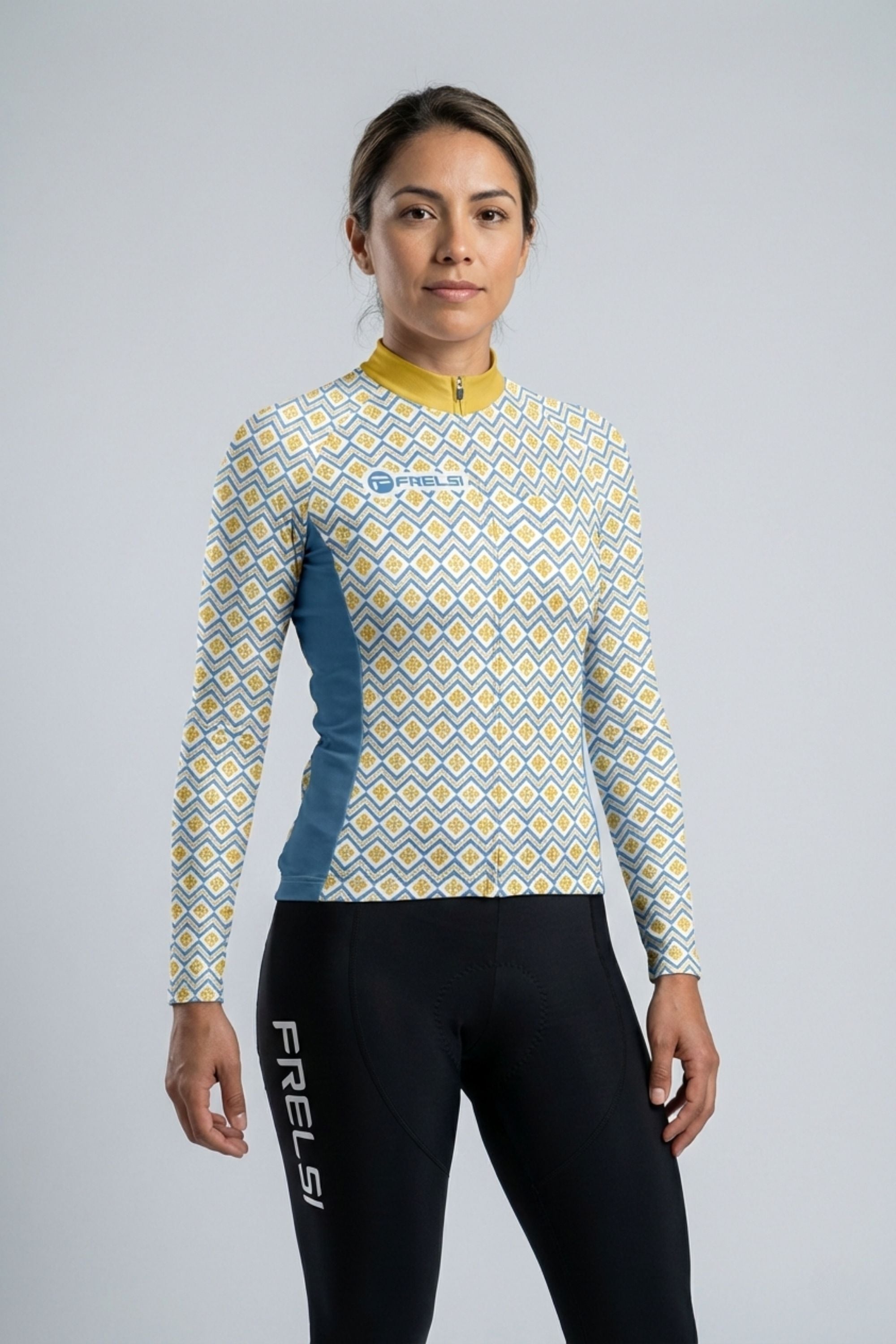 Person wearing a yellow and white cycling outfit on a plain background by Cycling Frelsi