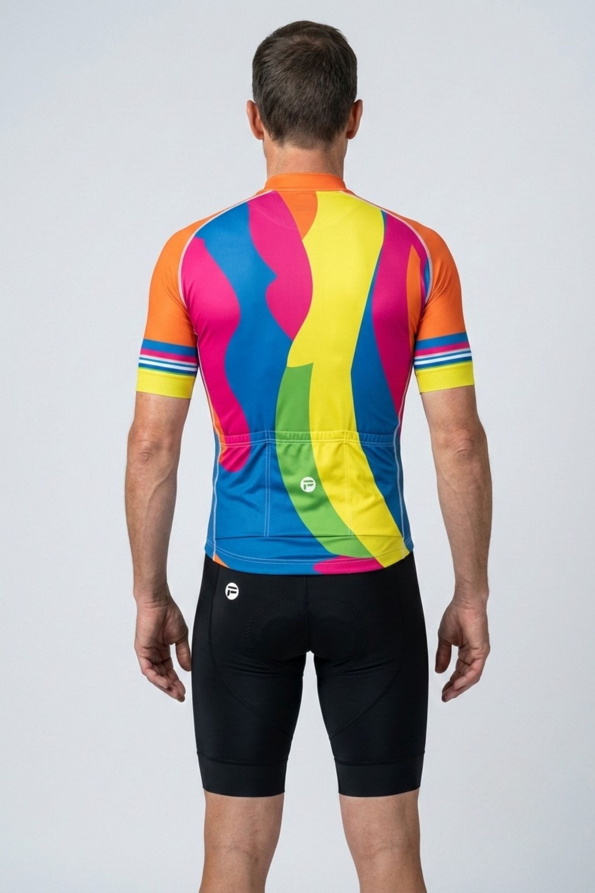 Person wearing a colorful cycling jersey and black shorts on a white background