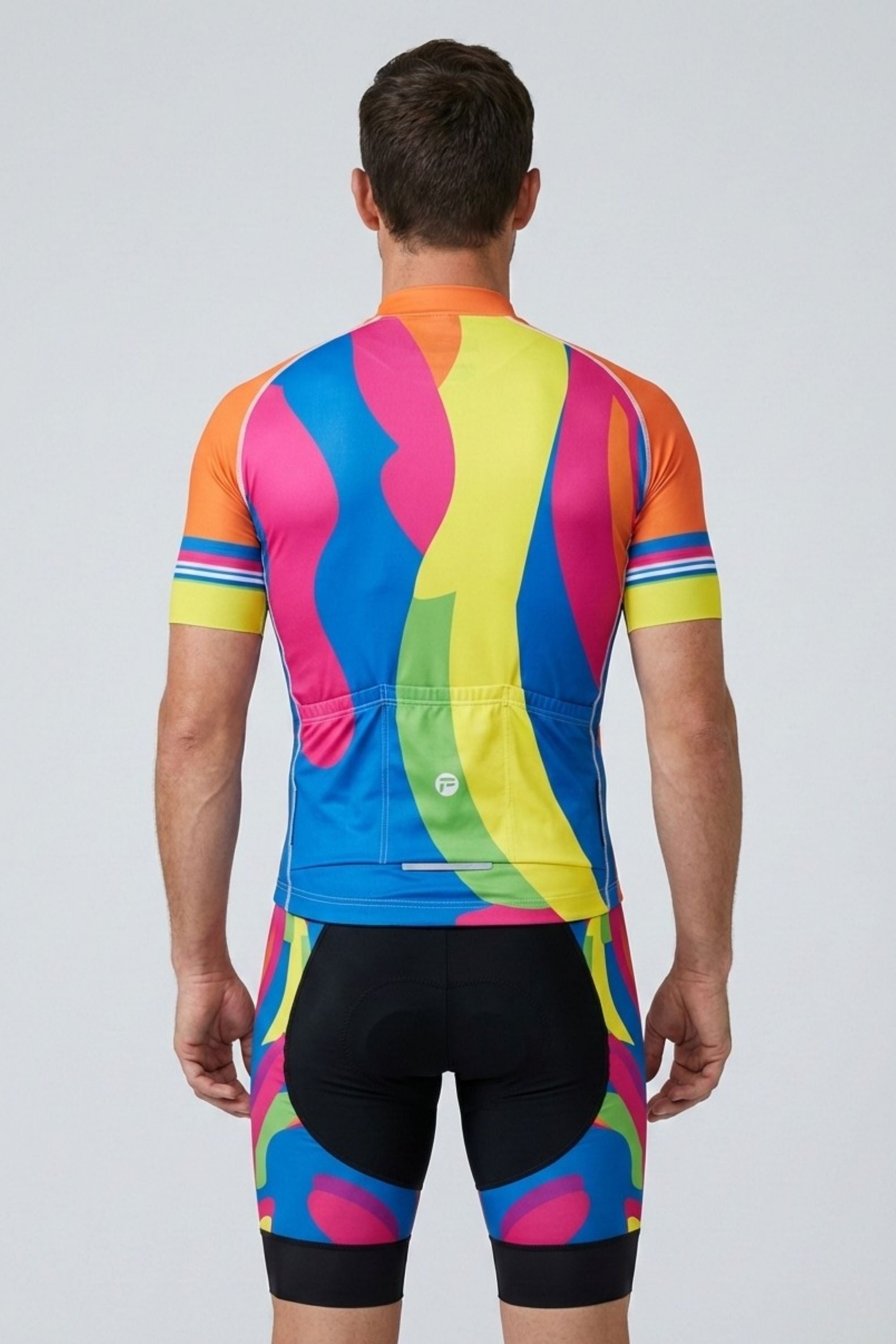 Person wearing a colorful cycling outfit with a vibrant pattern on a plain background
