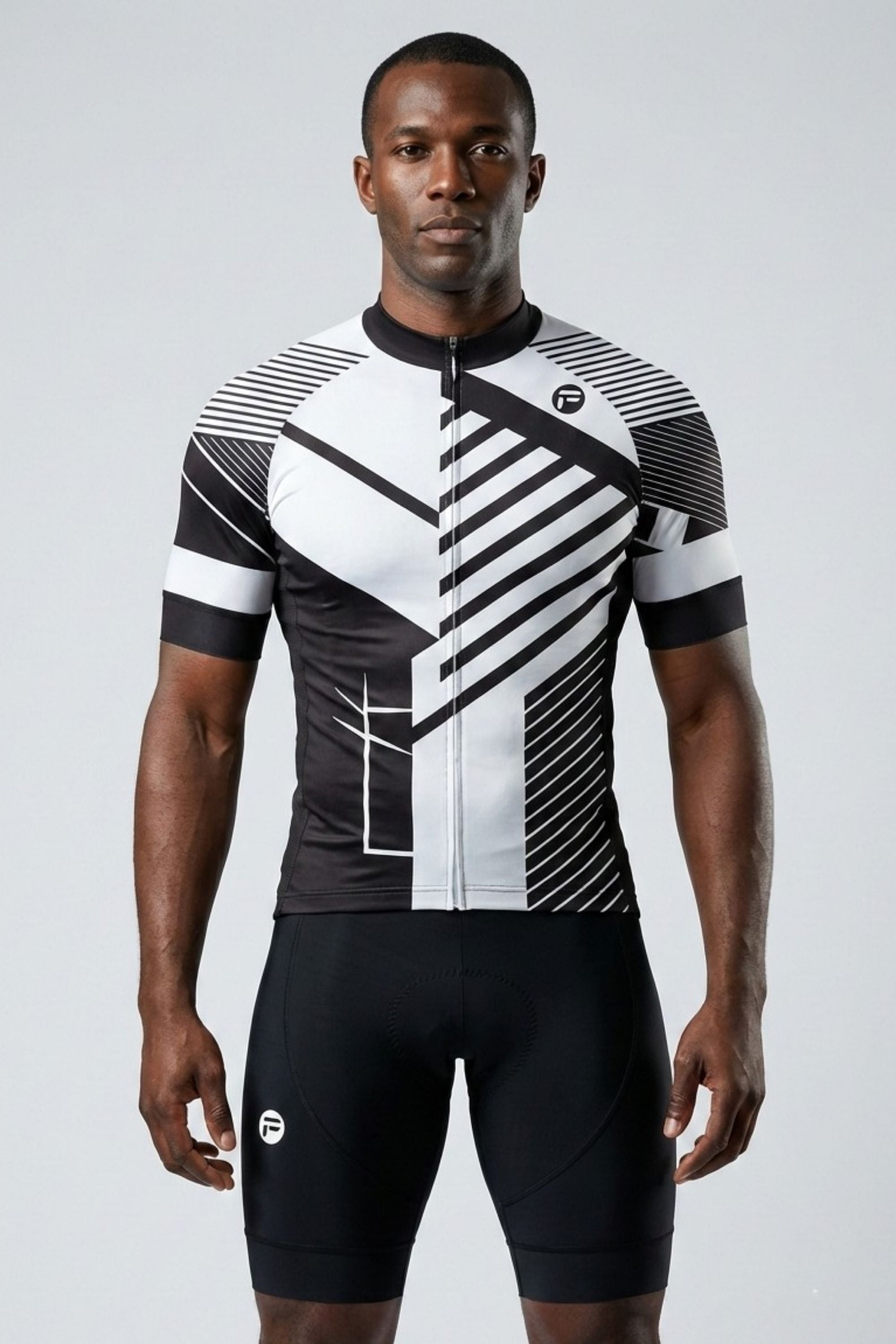 Person wearing a black and white cycling outfit on a gray background