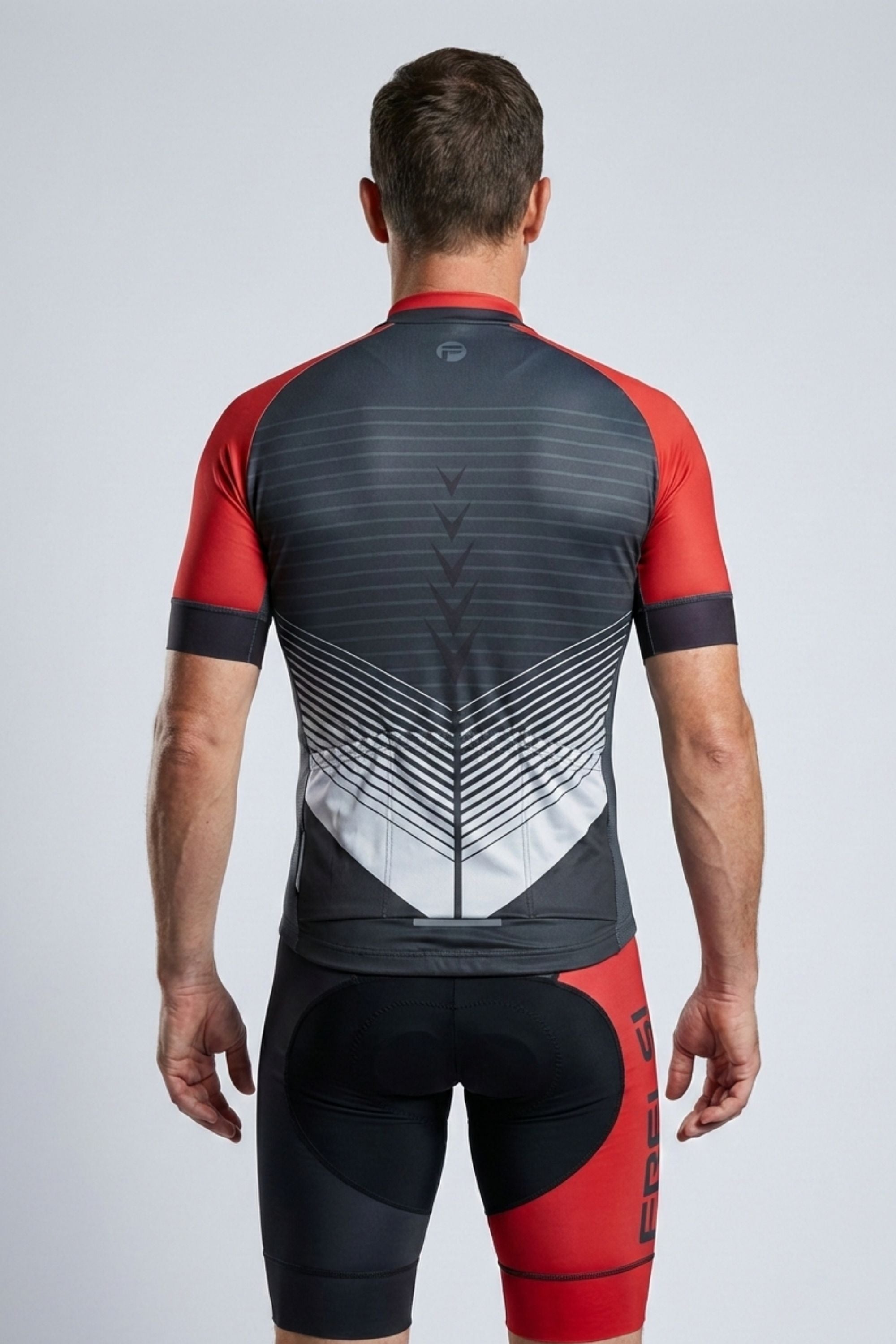 Person wearing a red and black cycling outfit with geometric pattern on a light gray background