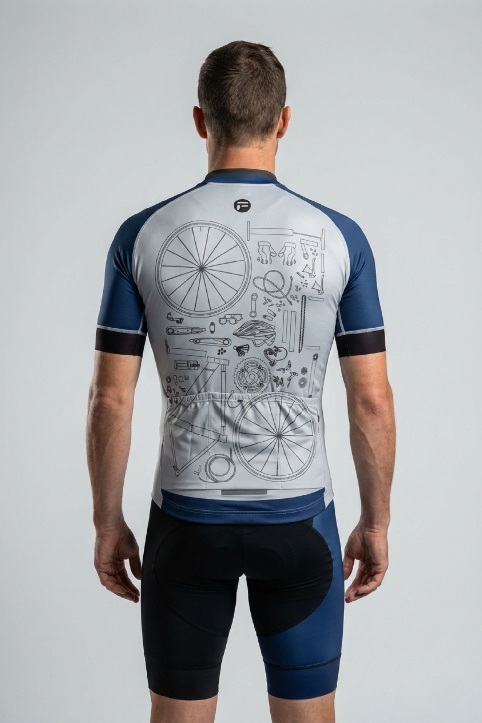 Person wearing a cycling jersey with technical design on the back against a gray background
