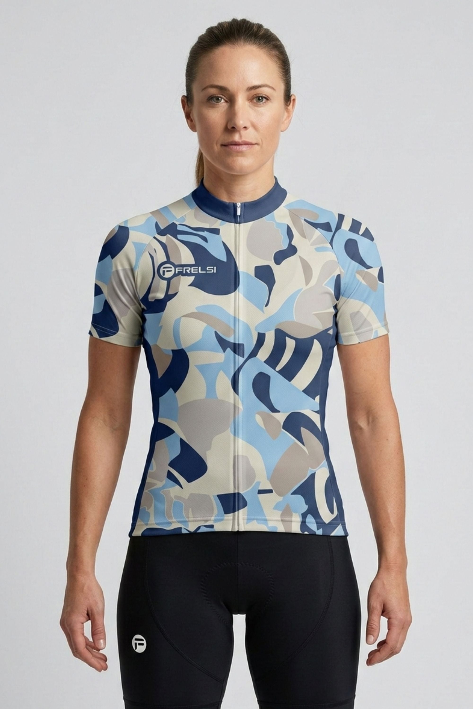 Woman wearing a camouflage-patterned cycling jersey on a plain background