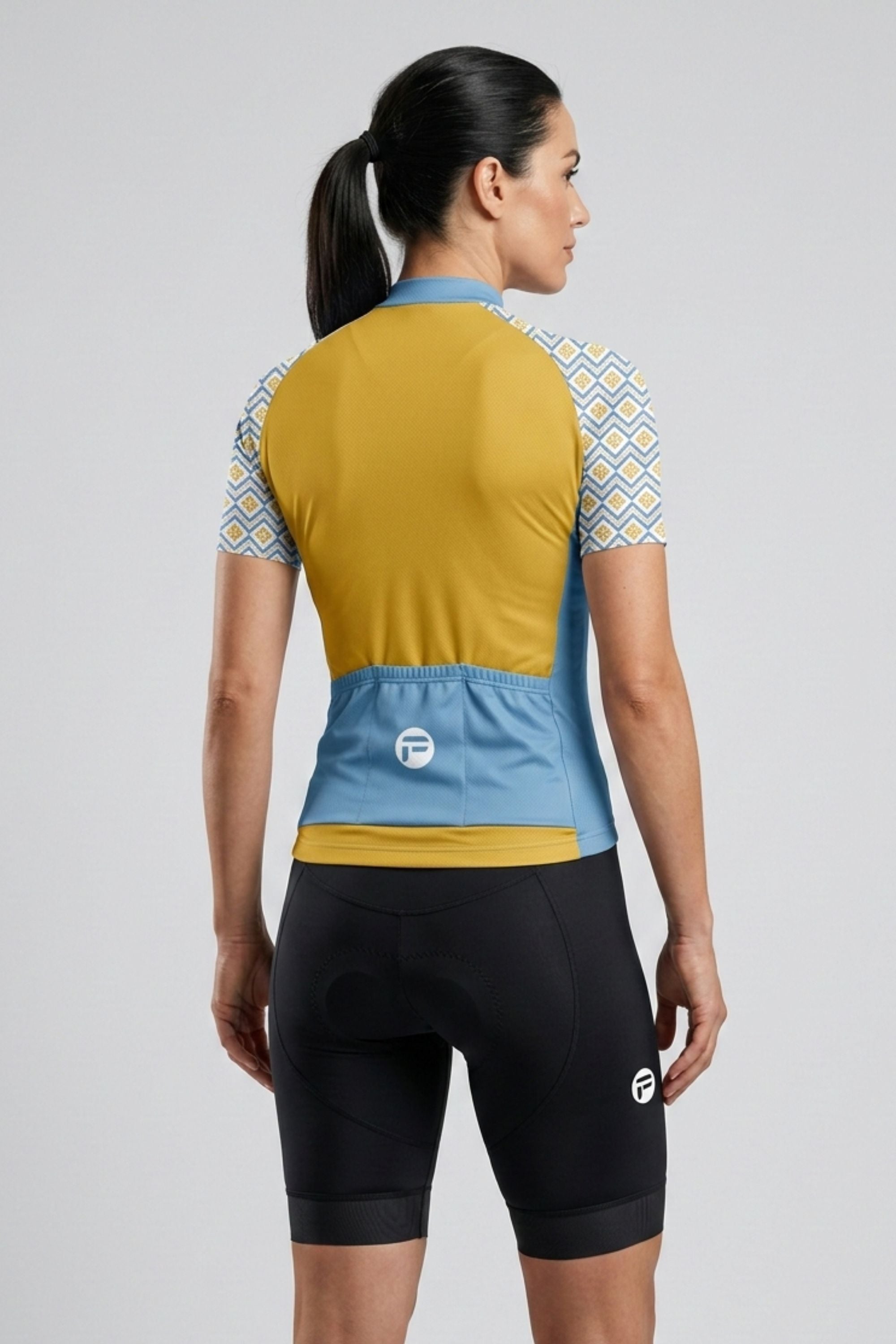 Person wearing a colorful cycling outfit with a gray background