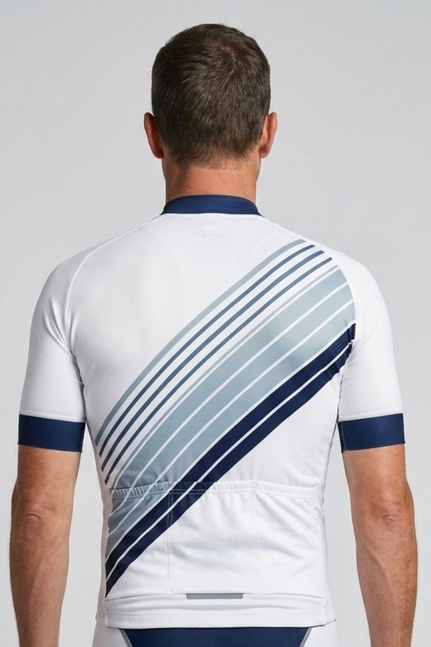 Person wearing a white and blue cycling outfit with a gray background