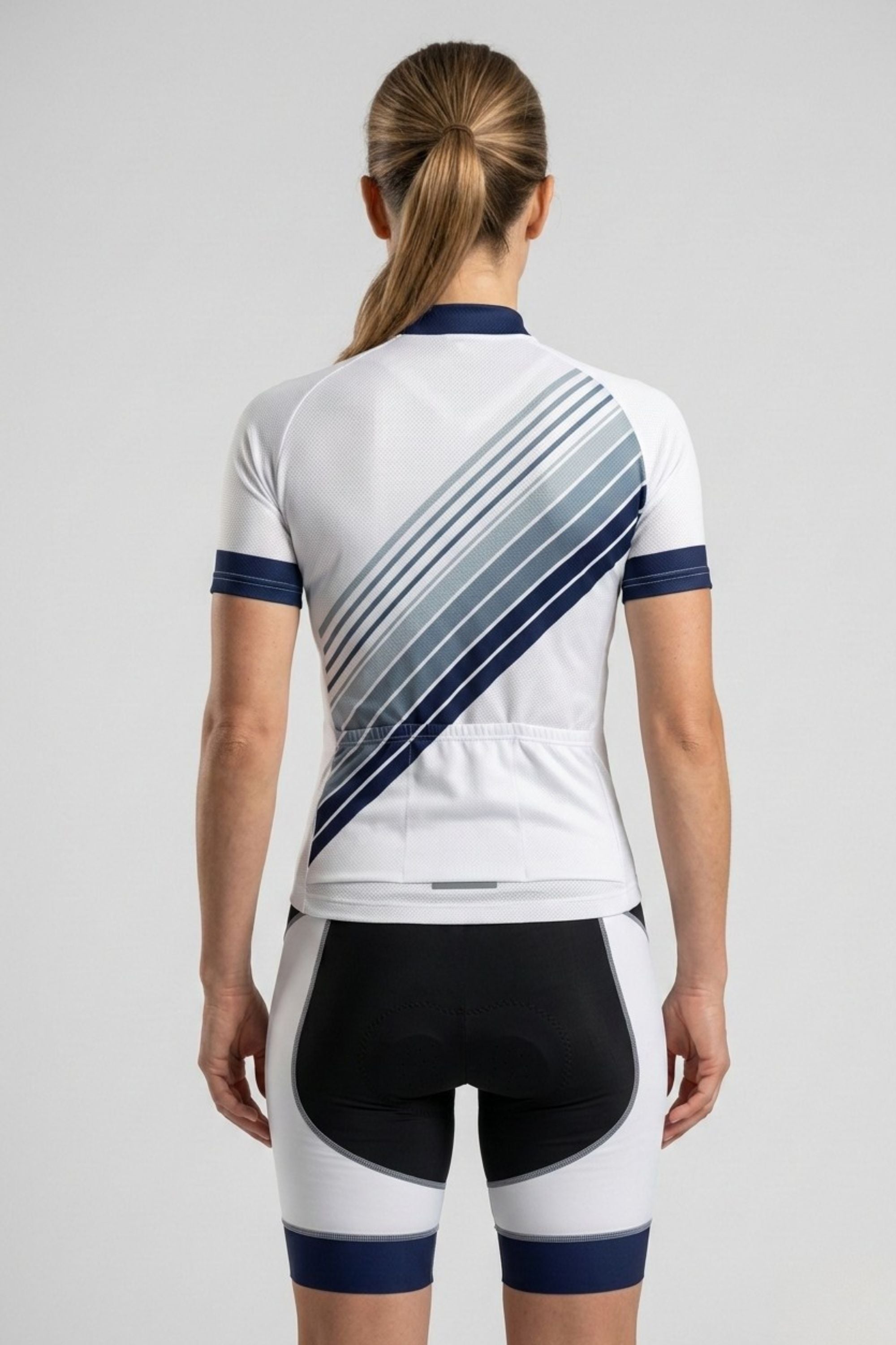 Person wearing a white cycling outfit with blue accents on a light gray background