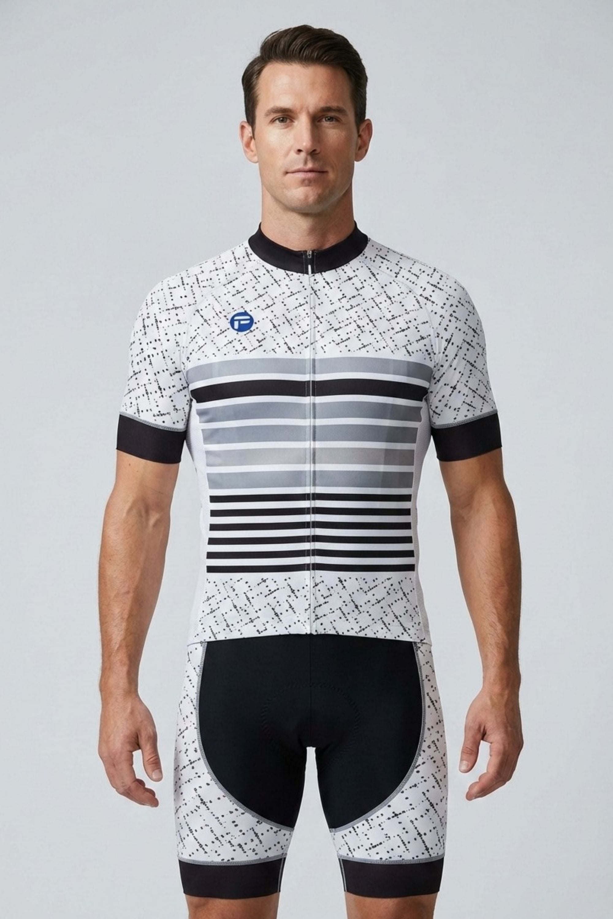 Man wearing a black and white cycling outfit with a patterned design on a gray background