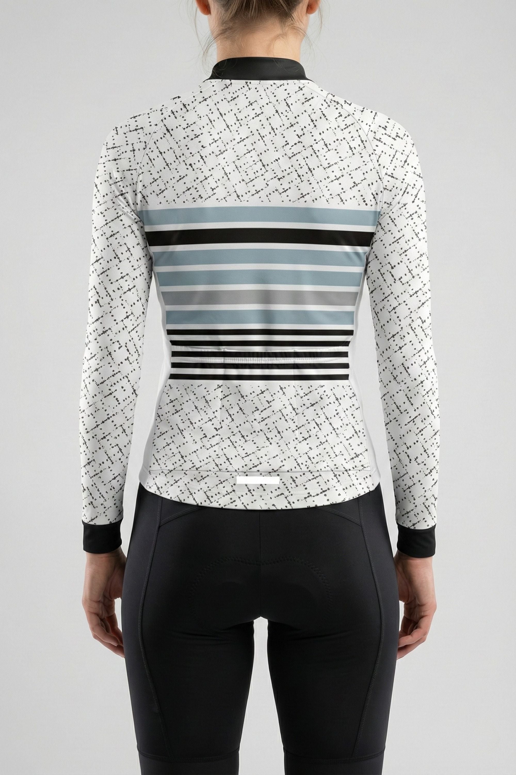 Person wearing a white cycling outfit with blue stripes on a plain background by Cycling Frelsi