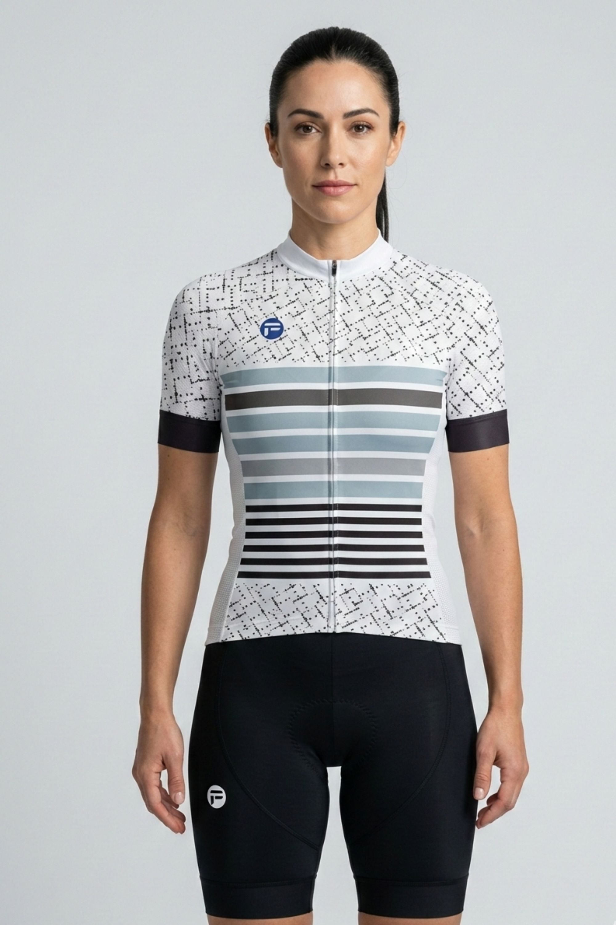 Woman wearing a white cycling jersey with black and blue stripes on a light gray background
