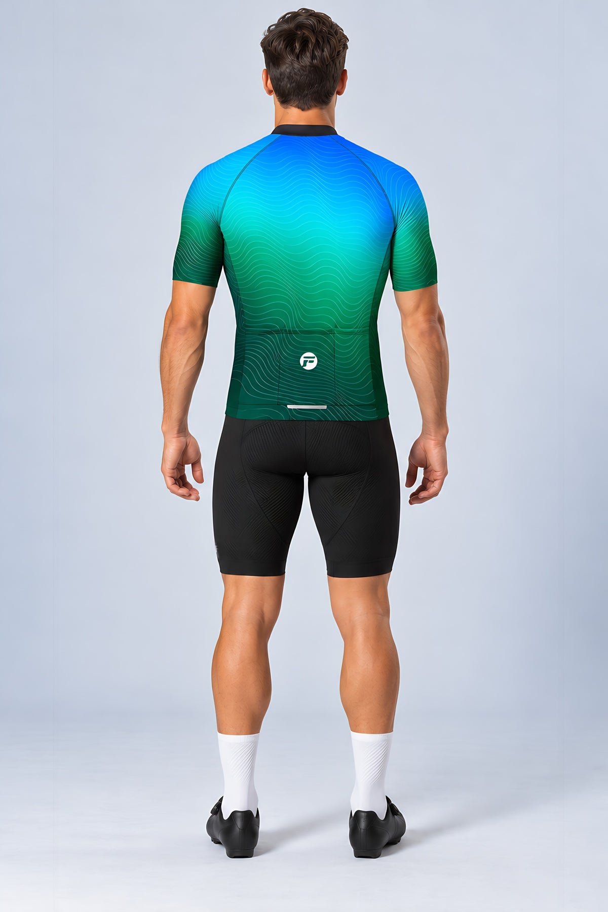 Man wearing the Ocean Pulse short sleeve cycling jersey with black bib shorts - back view