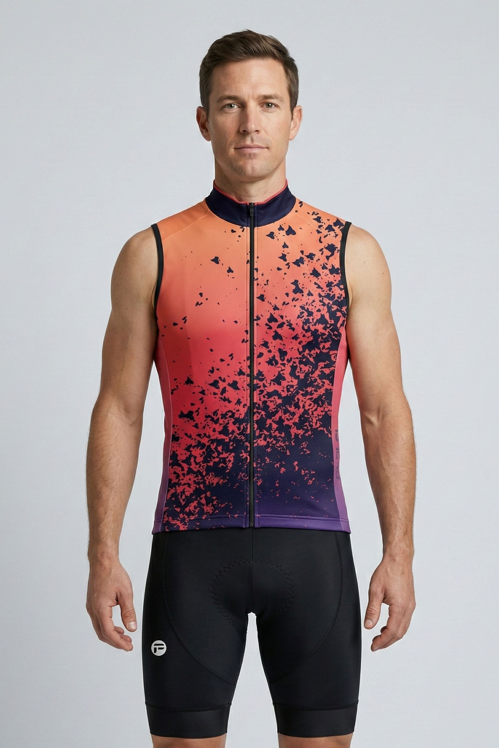 Man wearing a colorful cycling jersey and shorts on a gray background