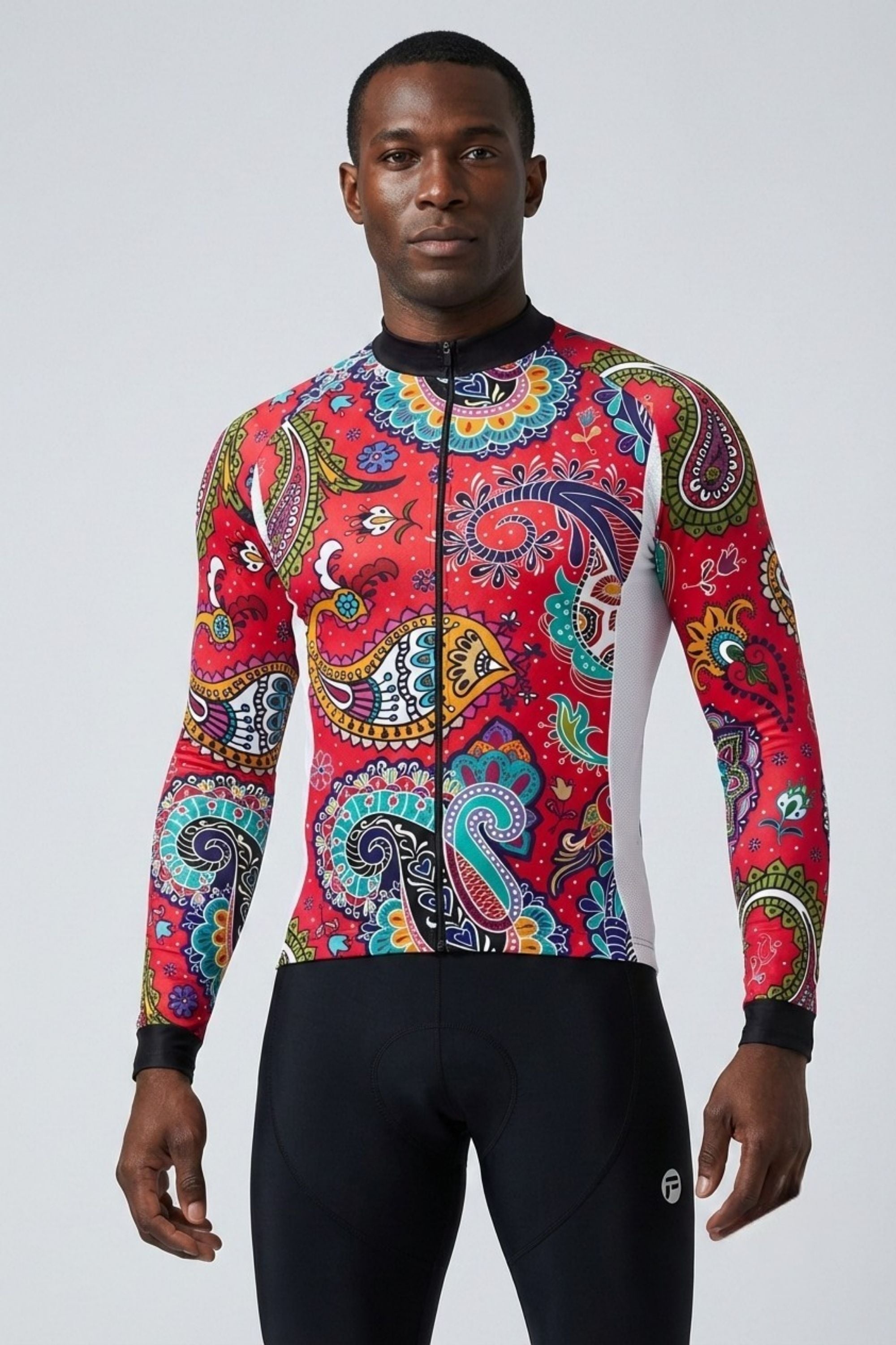 Man wearing a colorful paisley patterned cycling jersey on a white background