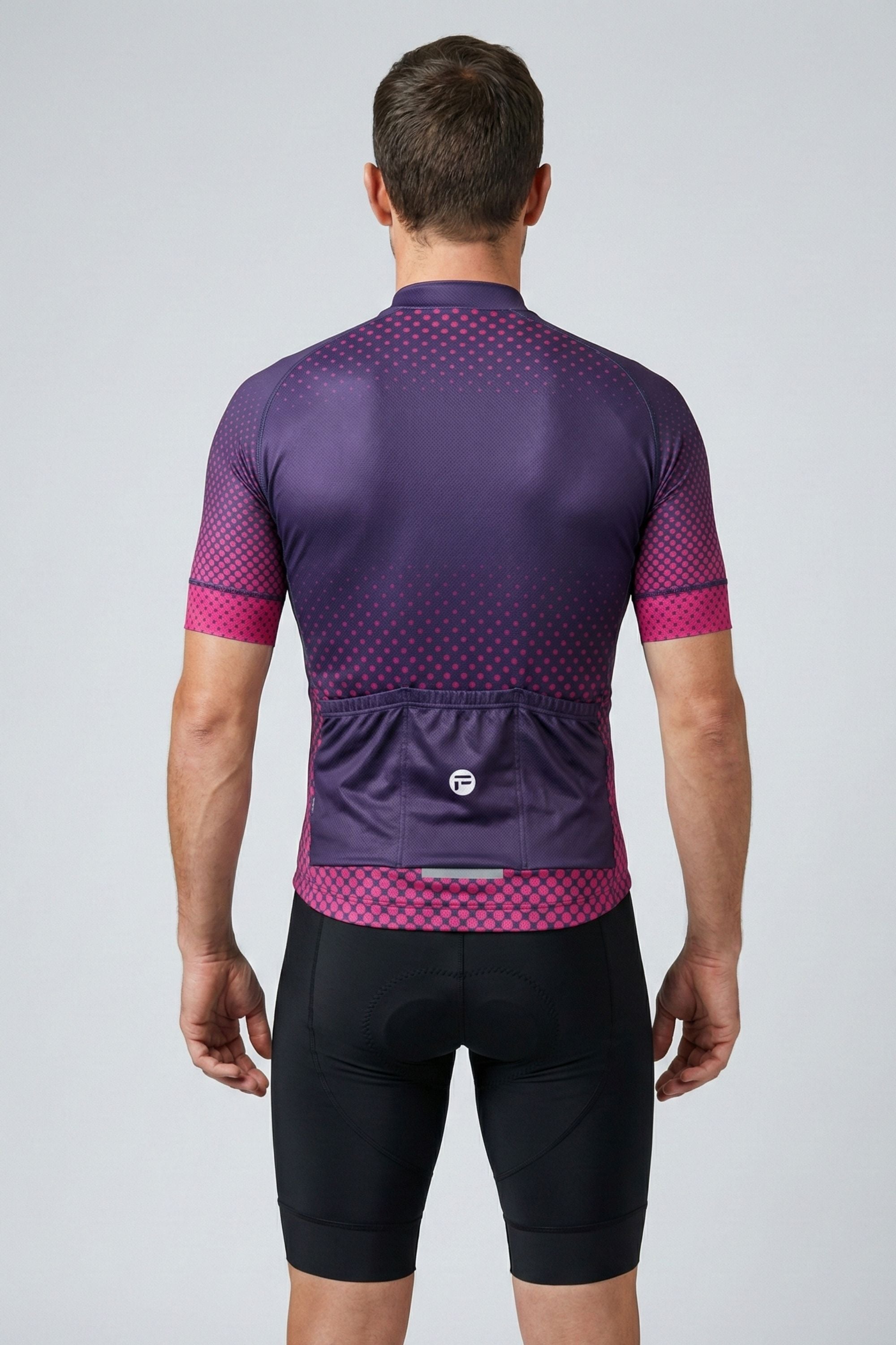 Person wearing a purple cycling jersey with pink accents on a gray background