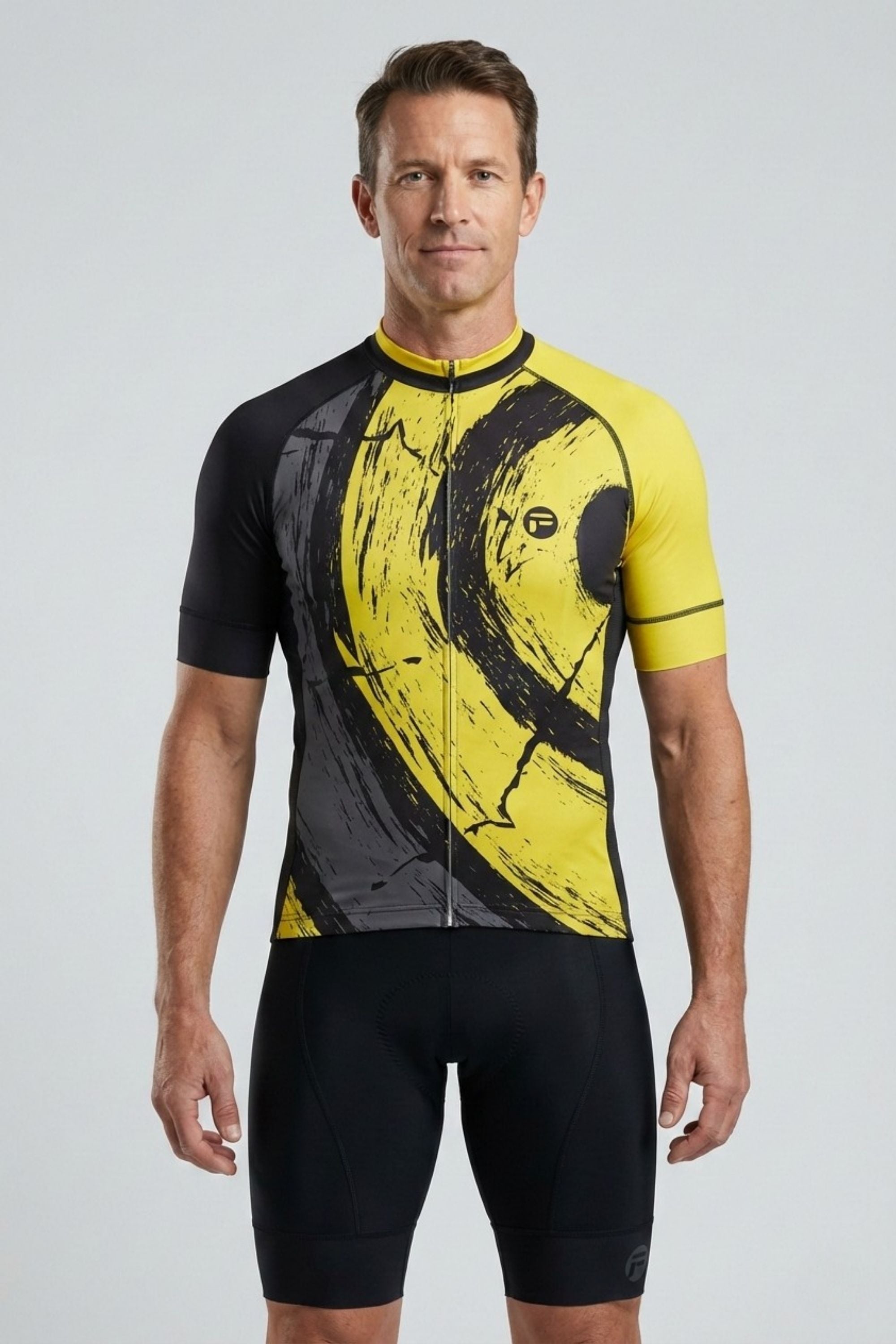 Man wearing a black and yellow cycling jersey on a light gray background