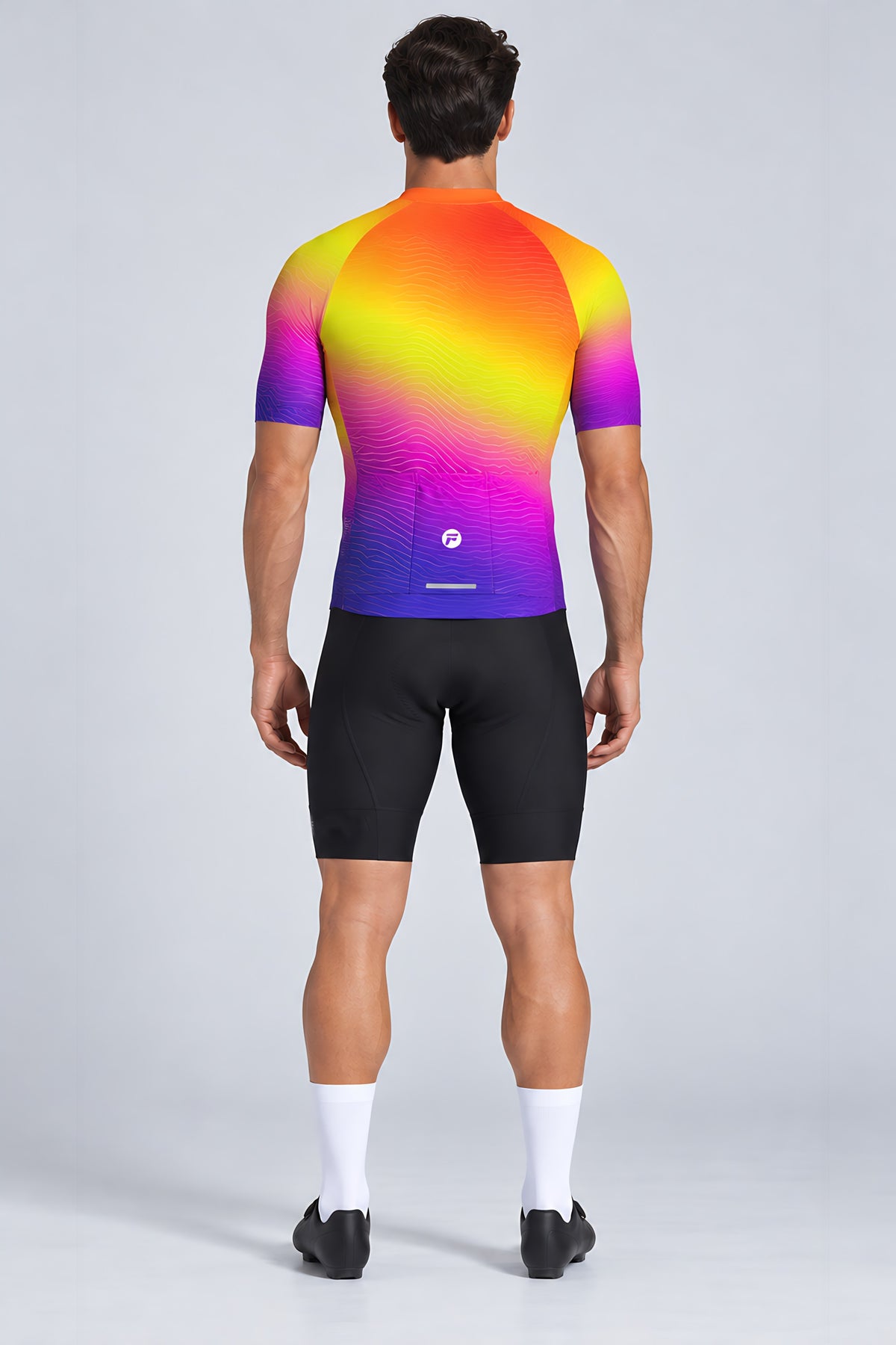 Man wearing the Sunset Pulse short sleeve cycling jersey with black bib shorts - back view