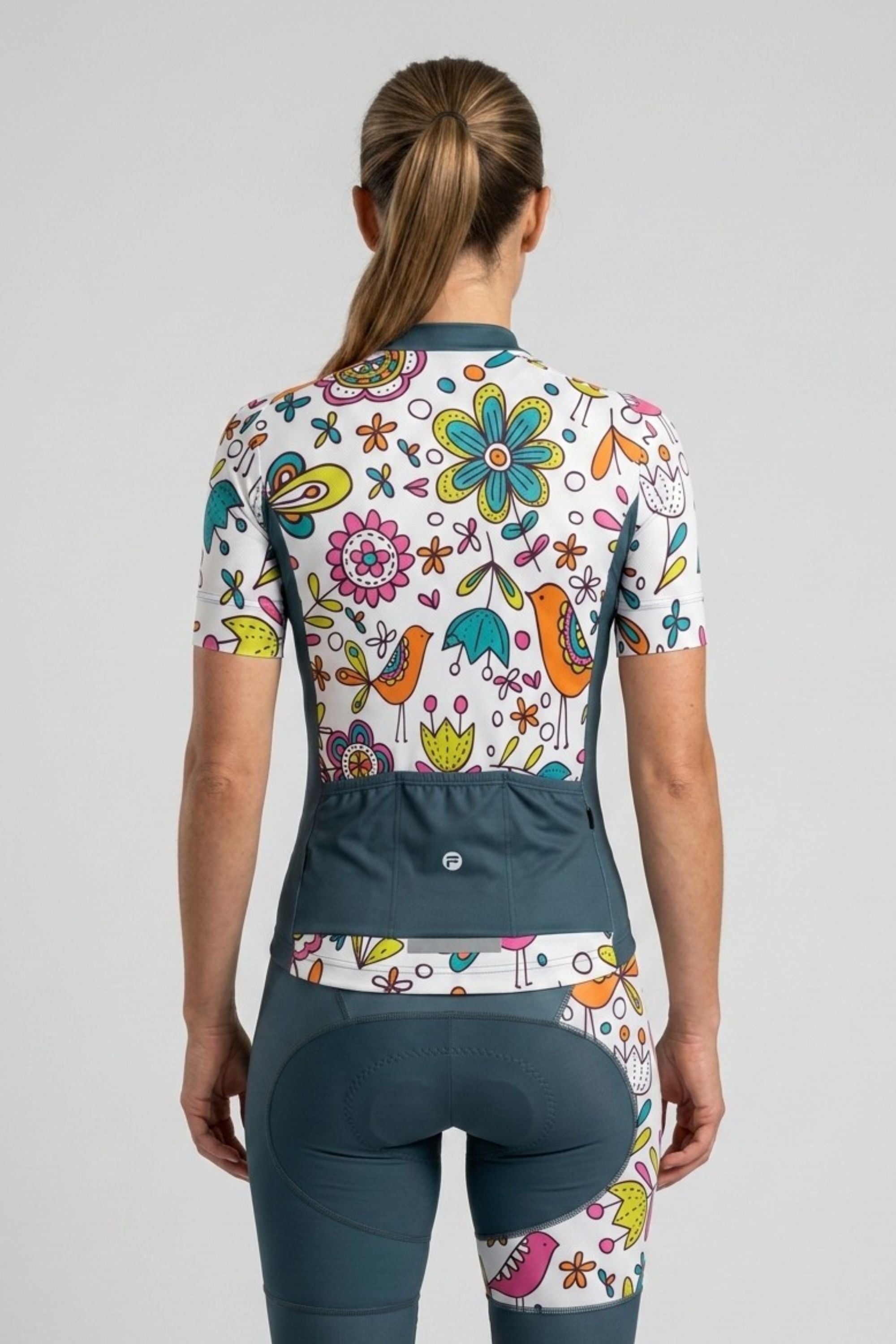Cycling outfit with colorful floral design on a plain background
