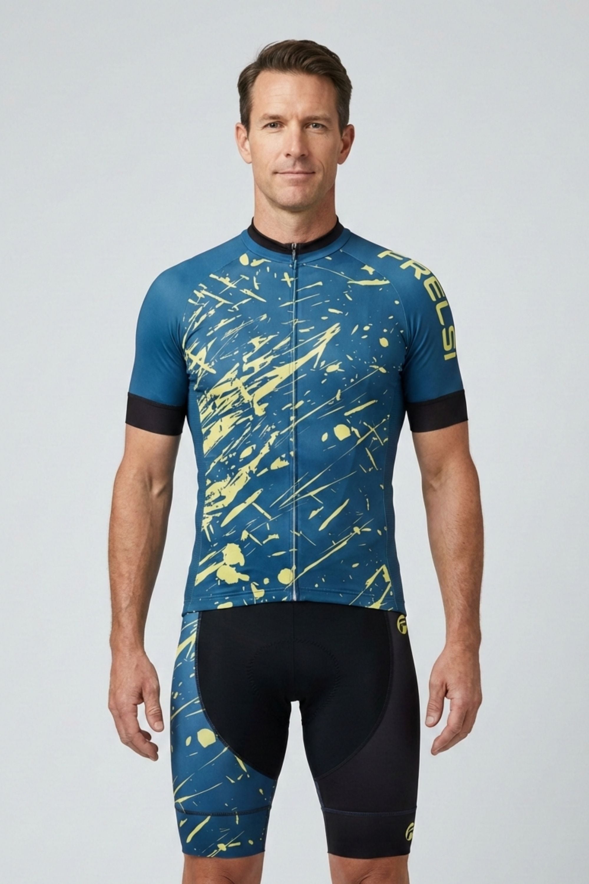 Man wearing a blue and yellow cycling jersey with black shorts on a light gray background