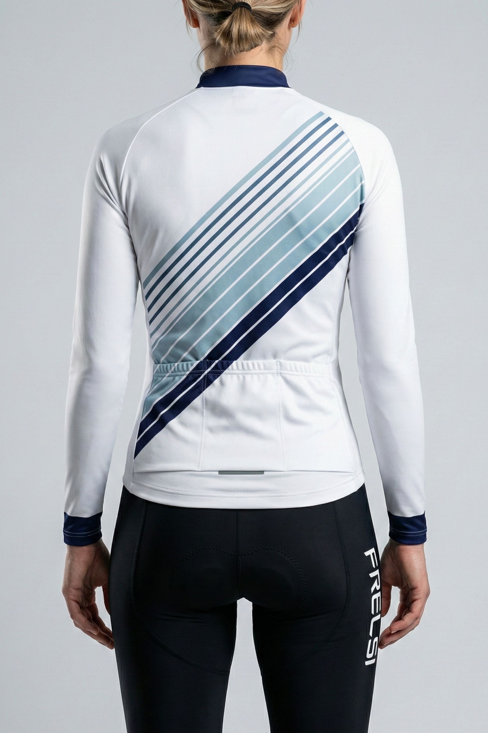 Person wearing a white cycling outfit with blue stripes on a plain background by Cycling Frelsi