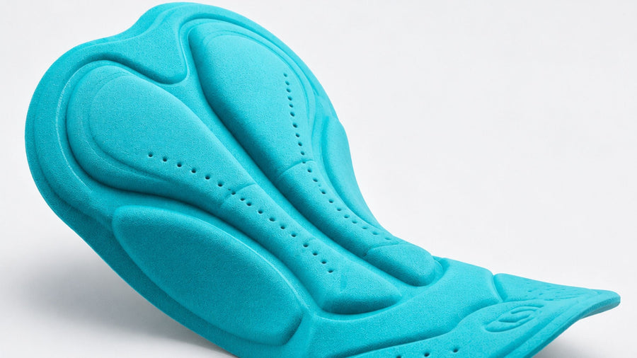 Close-up of a padded cycling chamois showing its shaped foam zones and ventilation holes