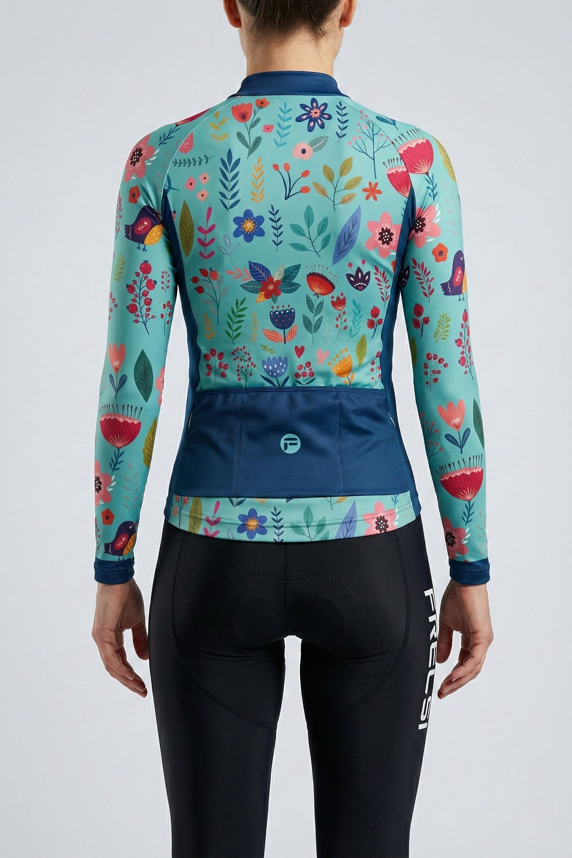 Person wearing a blue cycling jersey with colorful flowers accents by Cycling Frelsi on a gray background