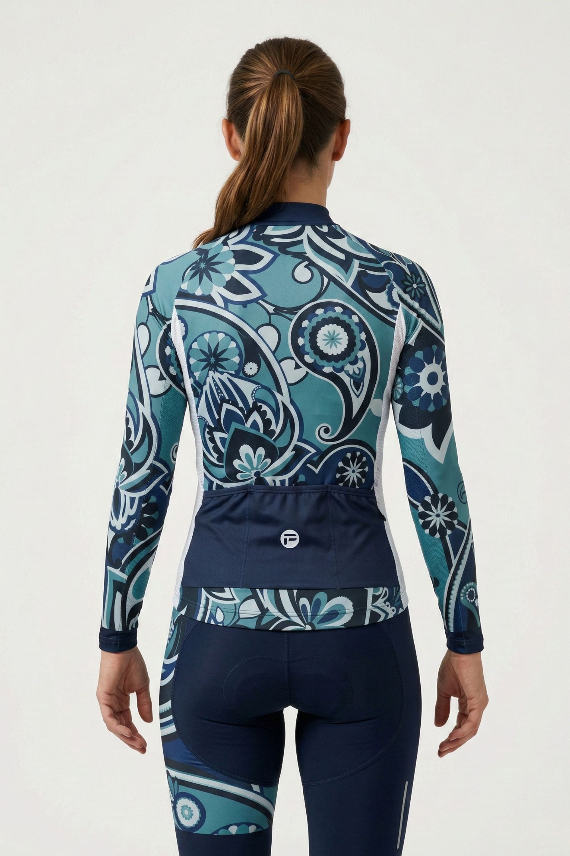 Person wearing a blue and white patterned long-sleeve top and pants on a white background