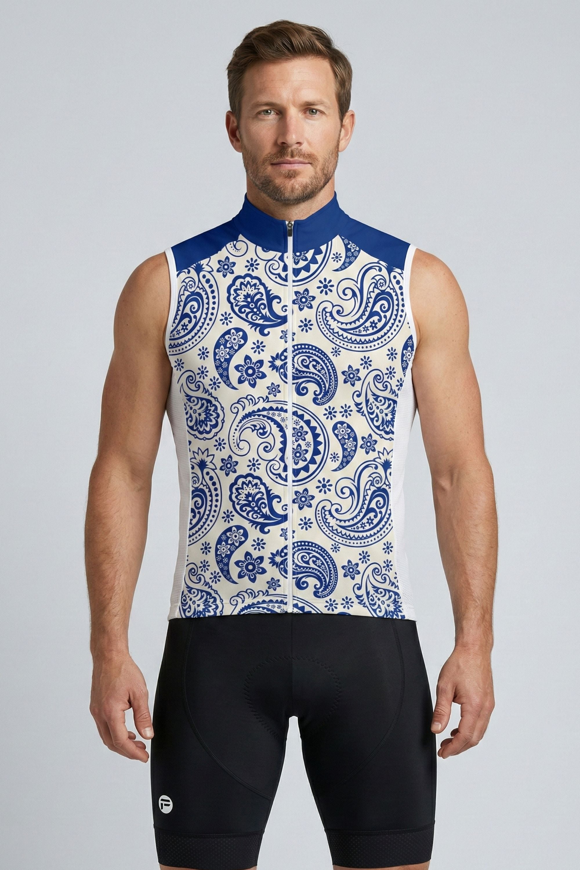 Man wearing a sleeveless cycling jersey with blue and white pattern on a gray background