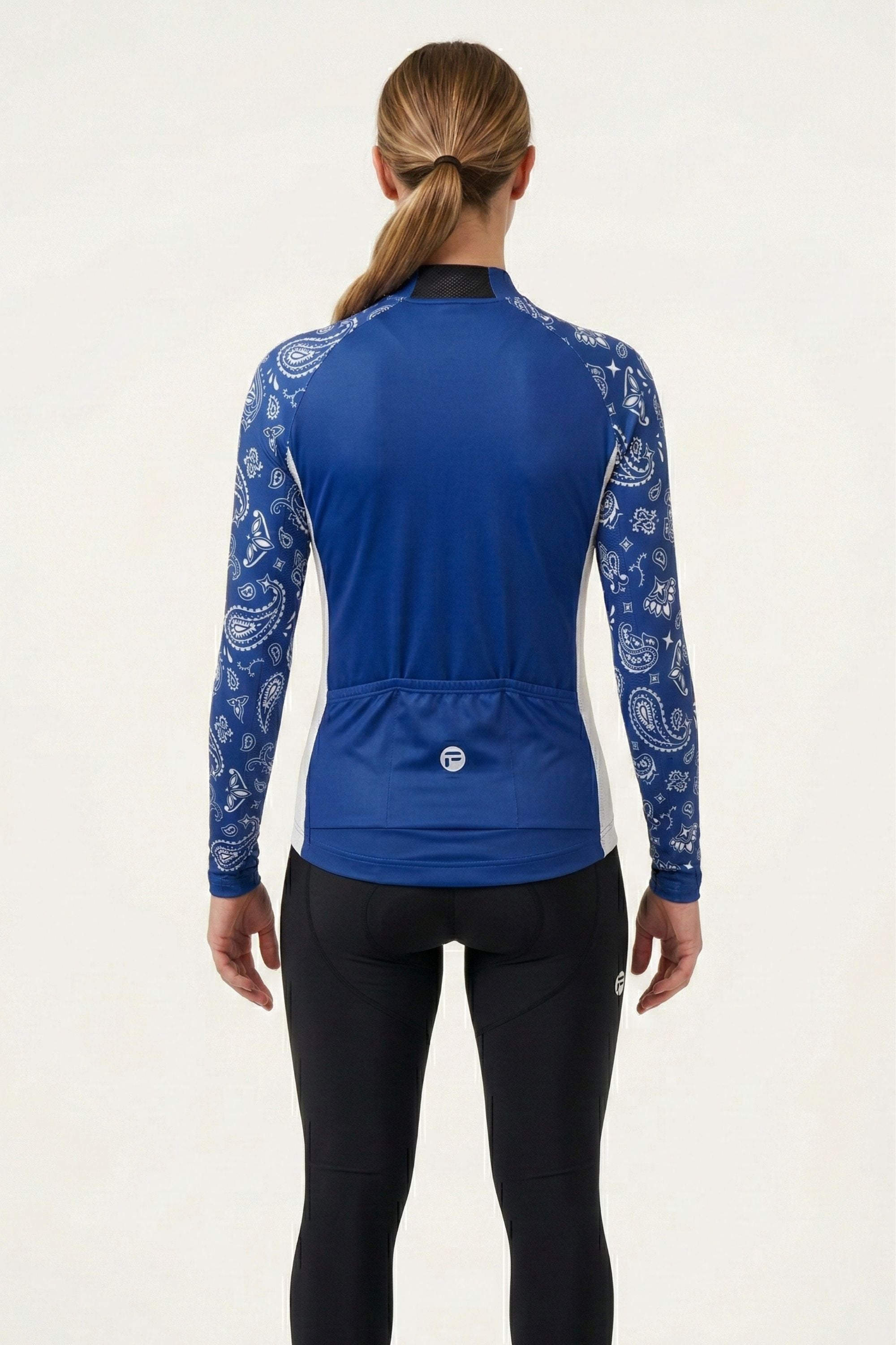 Person wearing a blue cycling jersey with white patterns on a white background