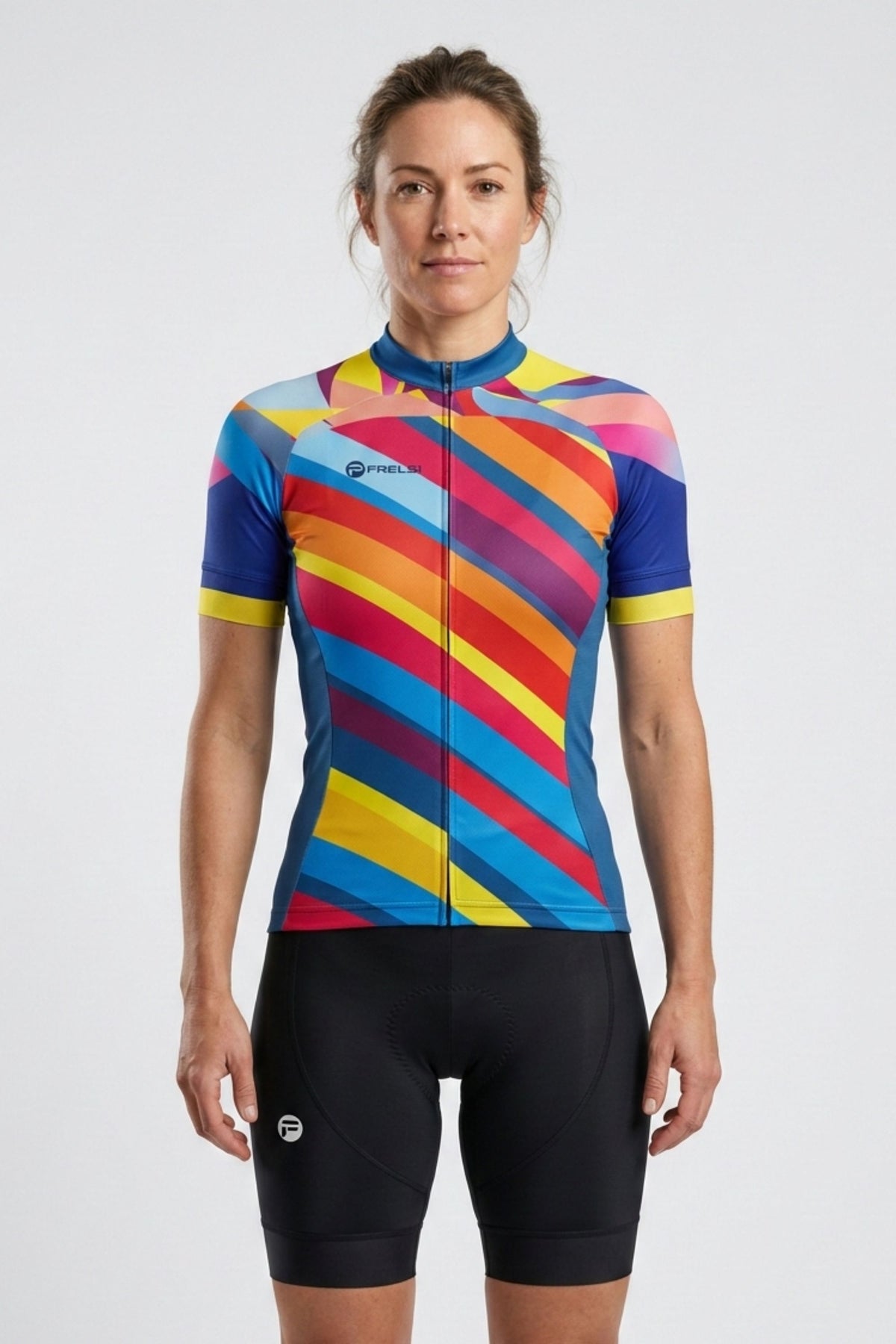 Woman wearing a colorful cycling jersey and black shorts on a white background