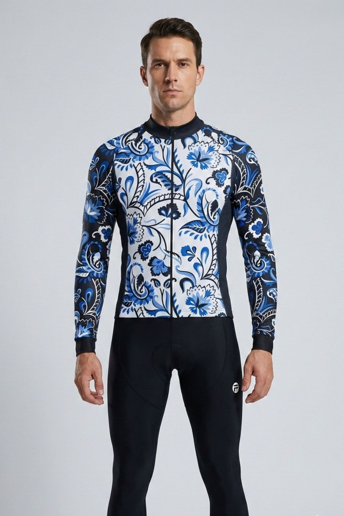 Man wearing a blue and white patterned long-sleeve shirt and black pants on a gray background