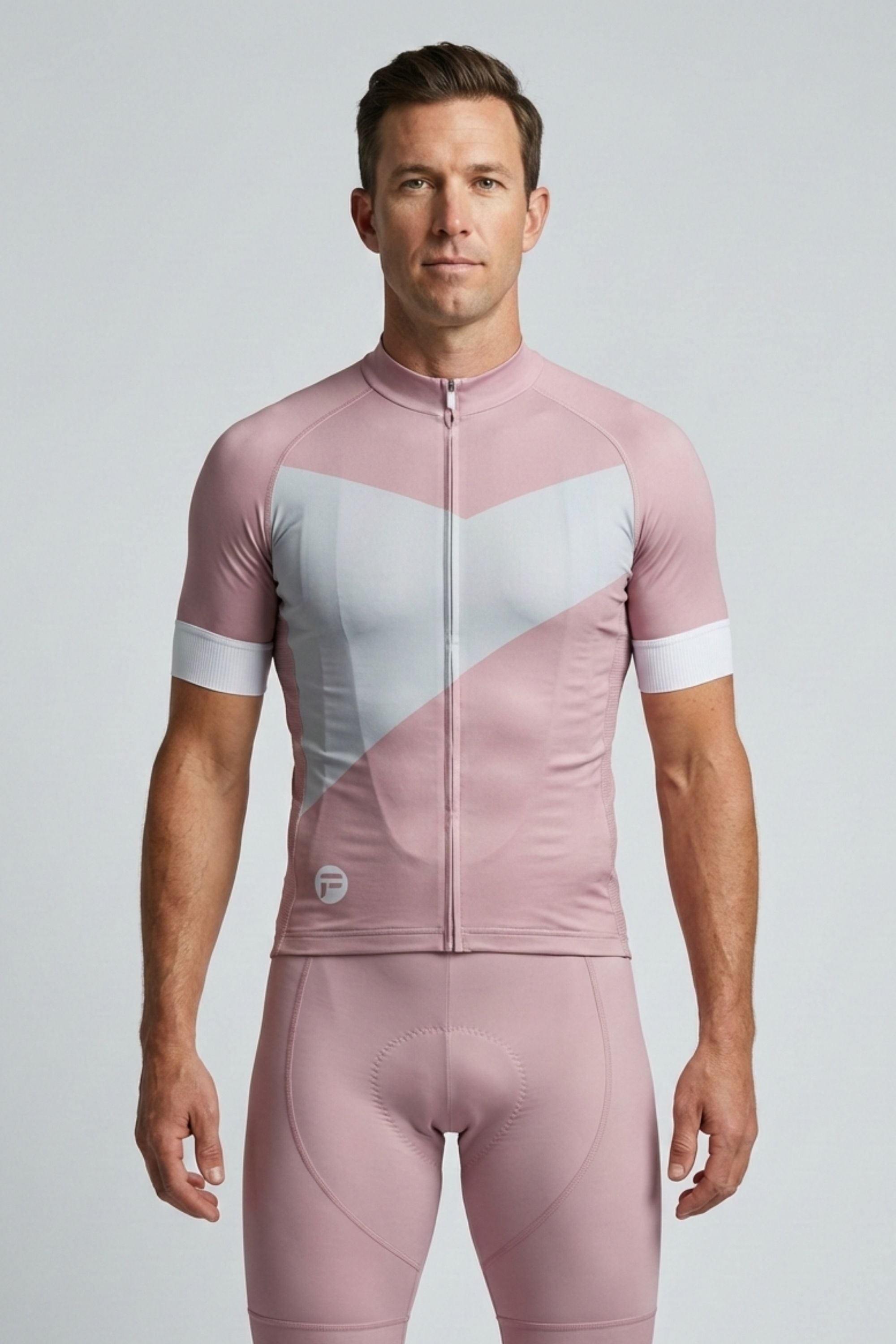 Man wearing a pink and white cycling suit on a light gray background