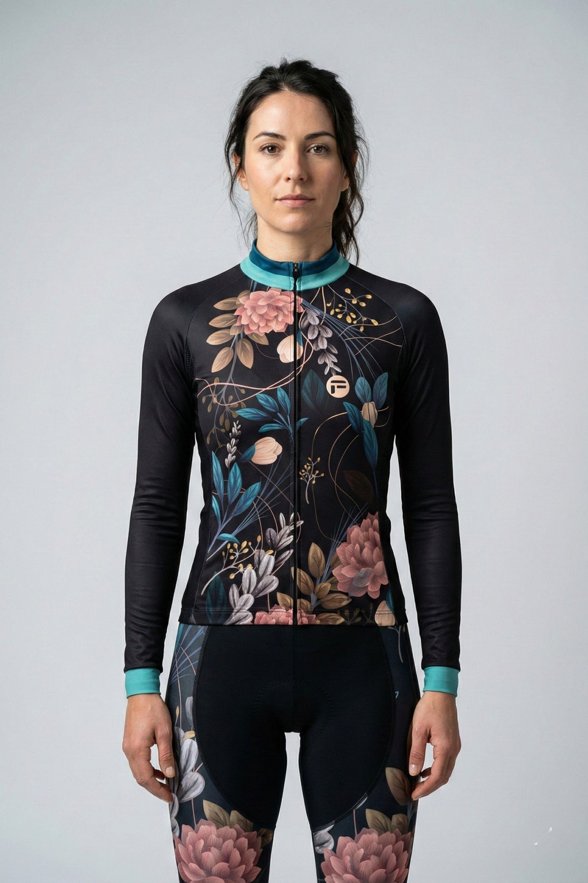Person wearing a black cycling jersey with Exotic_Spring flowers accents by Cycling Frelsi on a gray background
