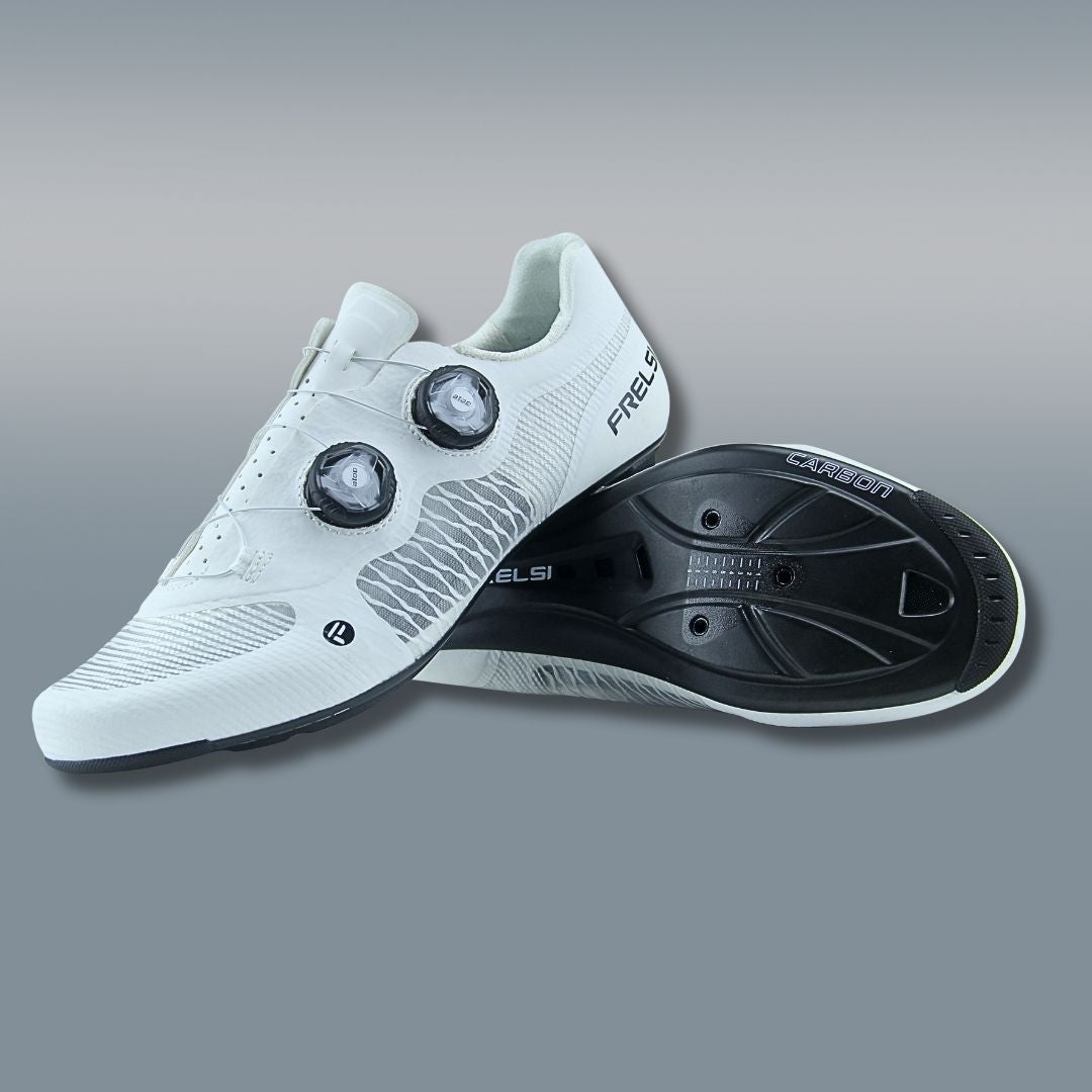 White Frelsi Pro Team cycling shoes featuring a full-carbon sole for stiffness and power transfer, breathable mesh upper for ventilation, dual Atop Dial closure for micro-adjustable fit, and replaceable aerodynamic heel cup.