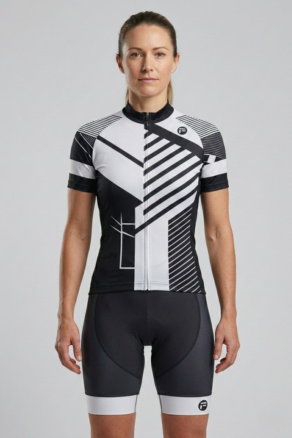 Person wearing a black and white cycling outfit on a gray background