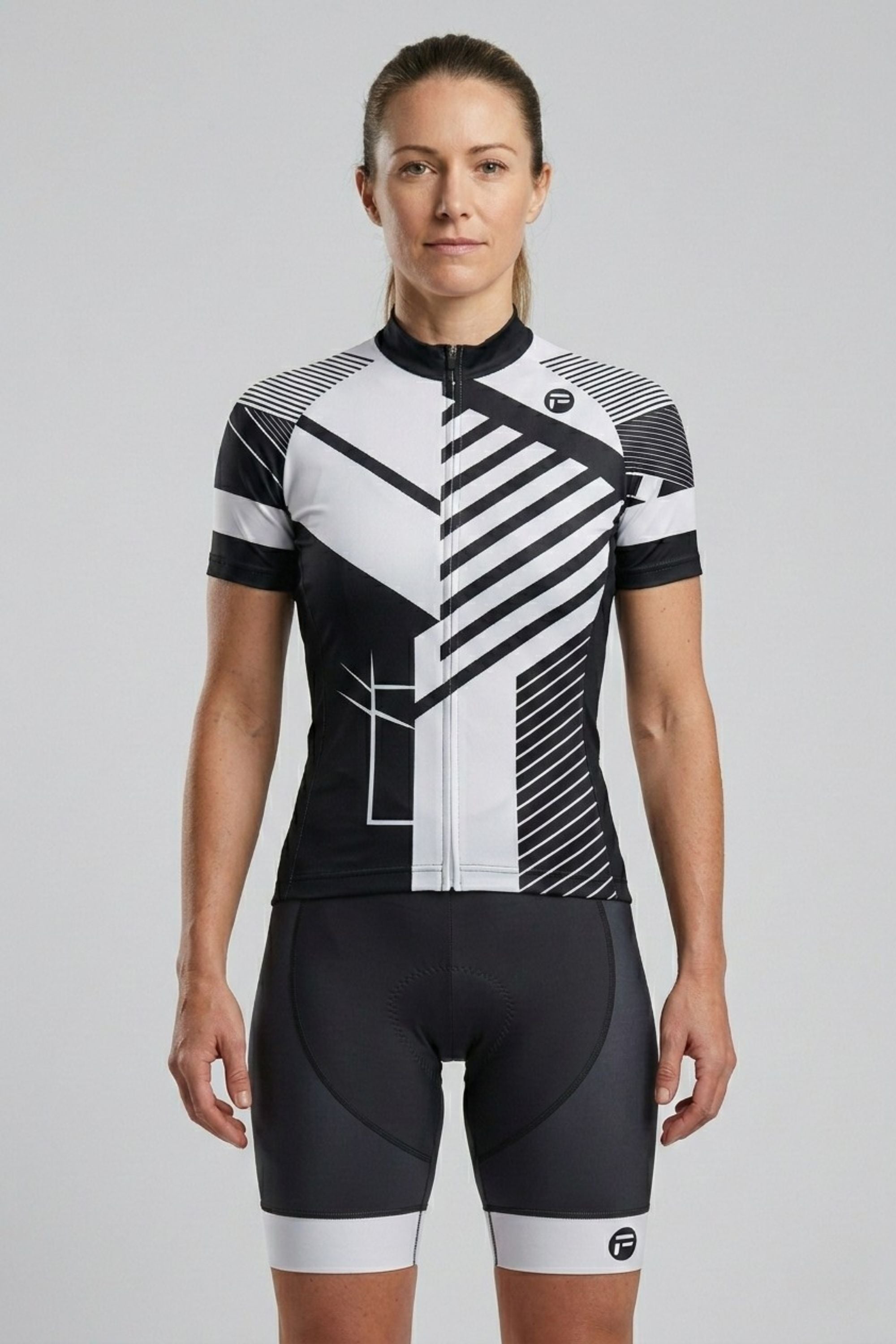 Person wearing a black and white cycling outfit on a gray background