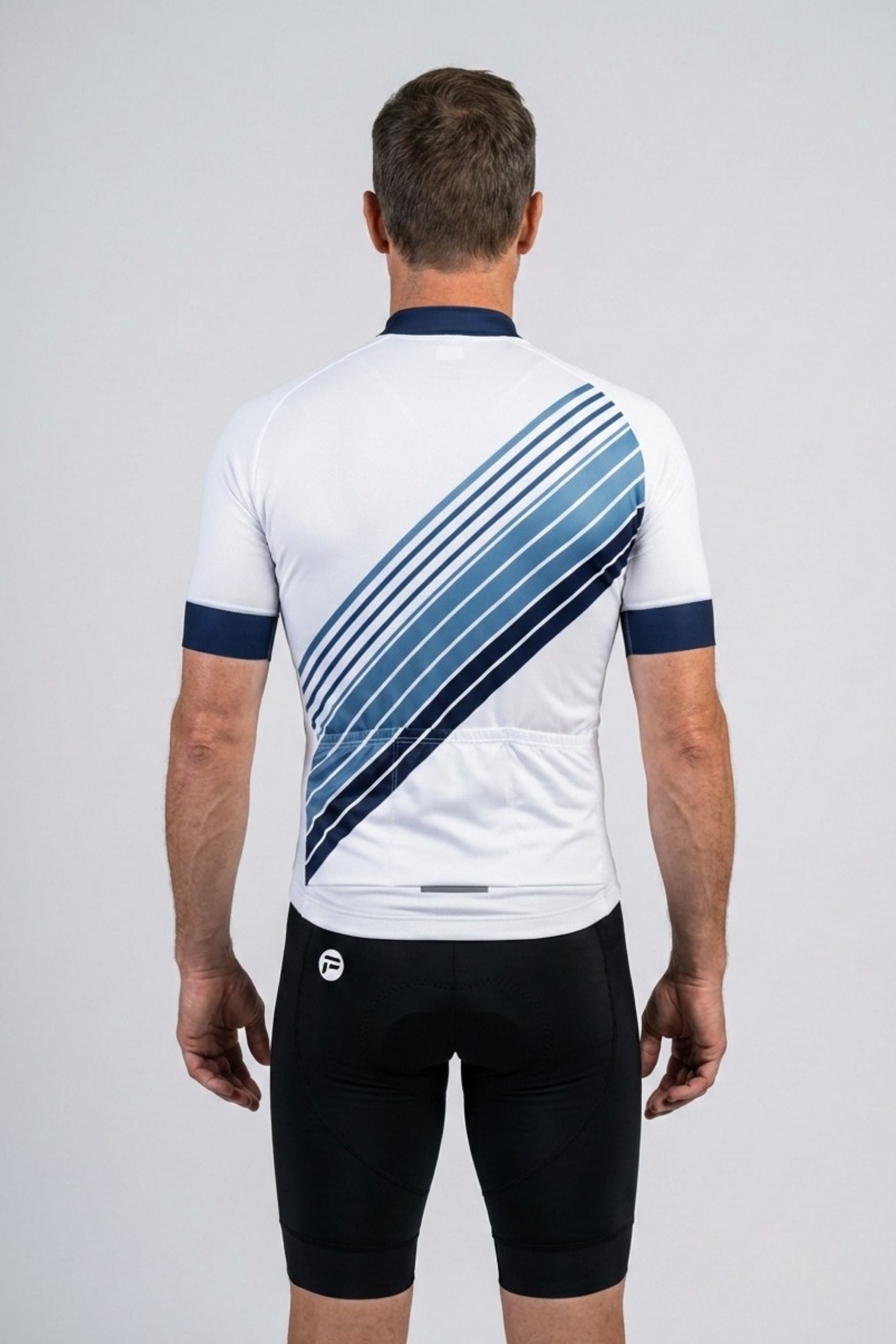 Person wearing a white cycling jersey with blue diagonal stripes on a gray background