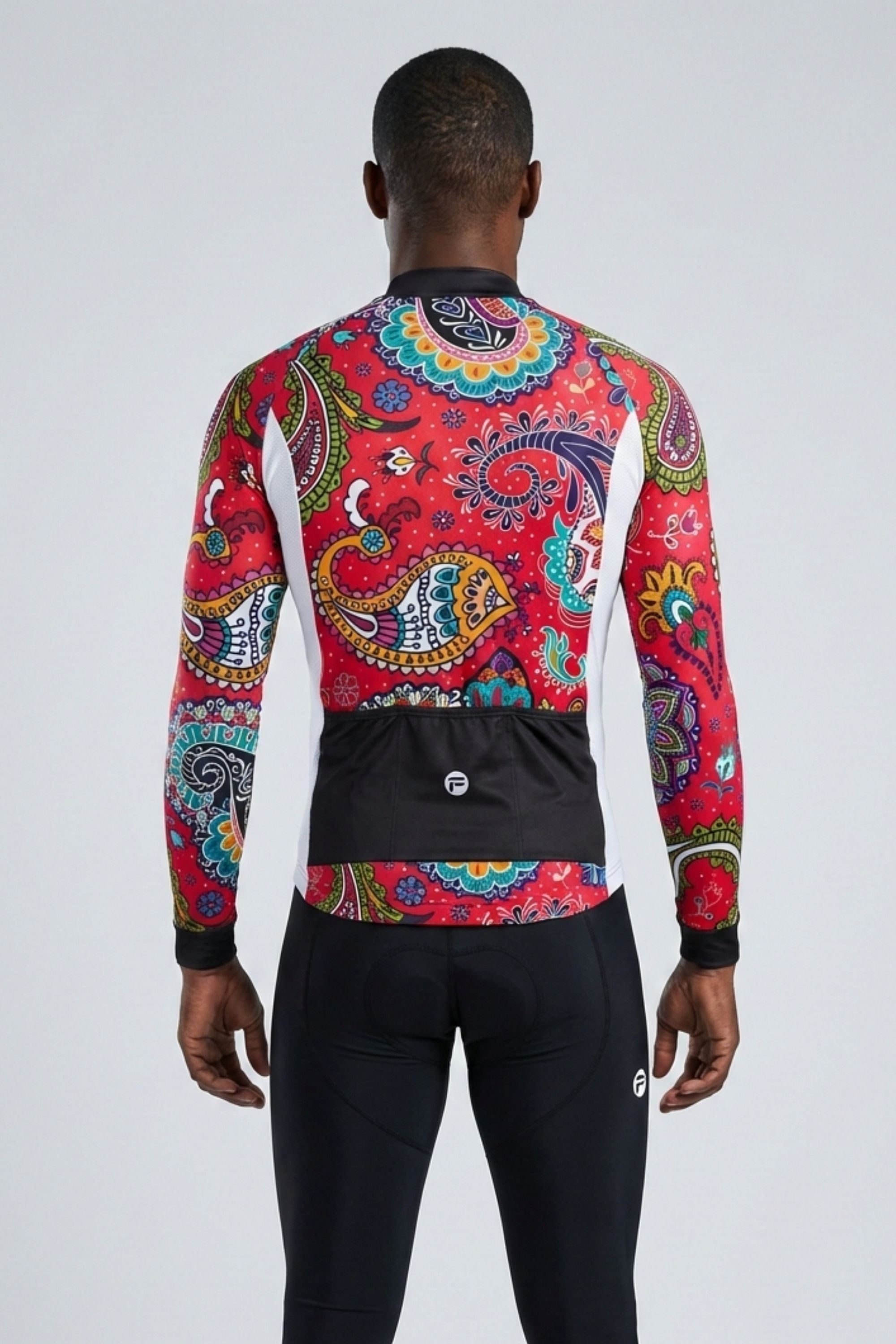 Person wearing a colorful patterned long-sleeve shirt on a plain background