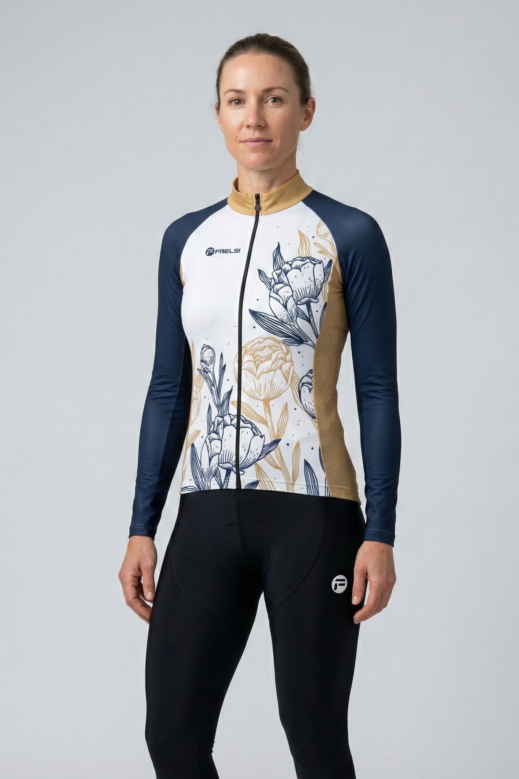 Person wearing a floral cycling jersey and black pants on a light gray background