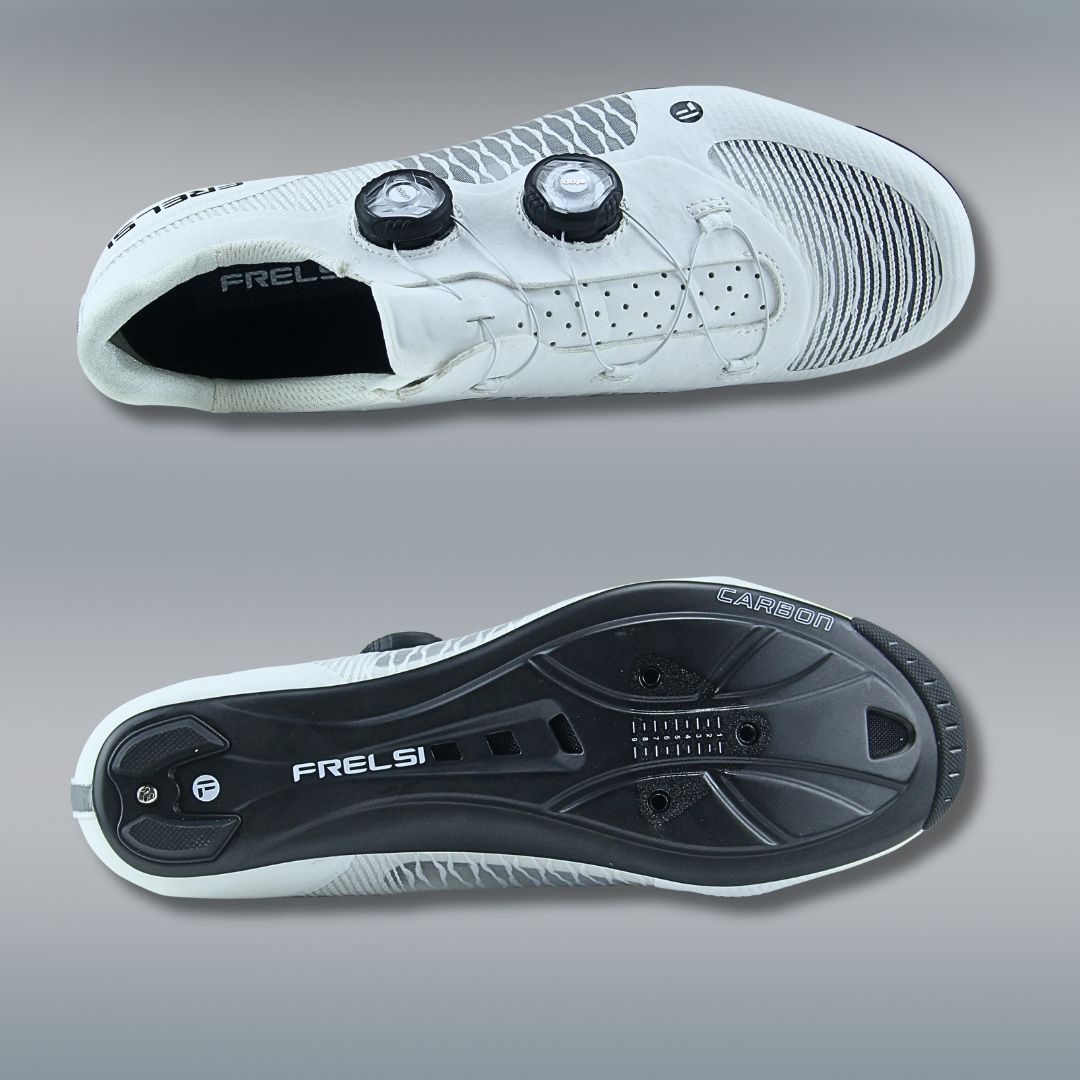 White Frelsi Pro Team cycling shoes featuring a 131g full-carbon sole for stiffness and power transfer, breathable mesh upper for ventilation, dual Atop Dial closure for micro-adjustable fit, and replaceable aerodynamic heel cup.