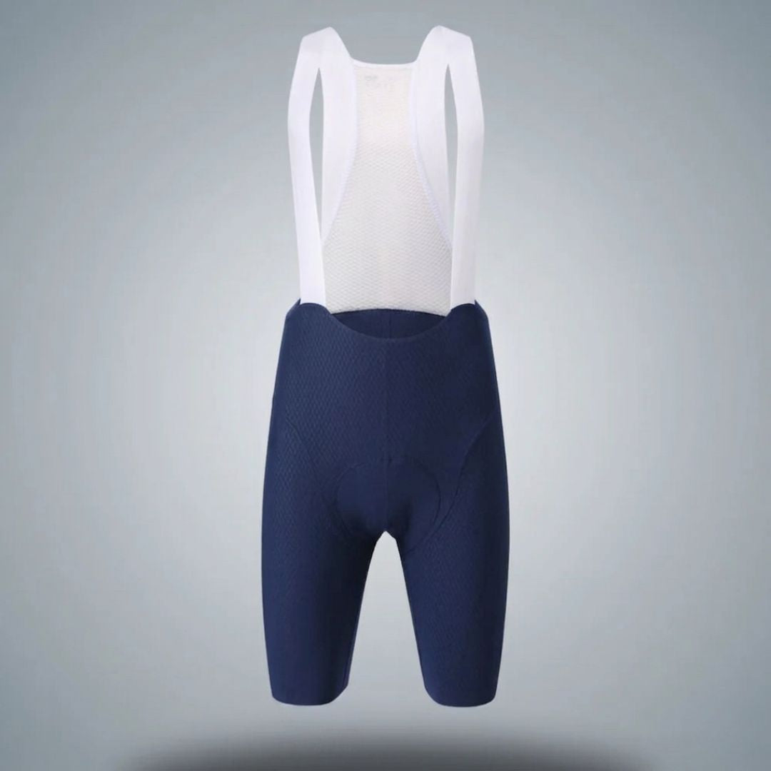 Navy cycling bib shorts with white top on a gray background