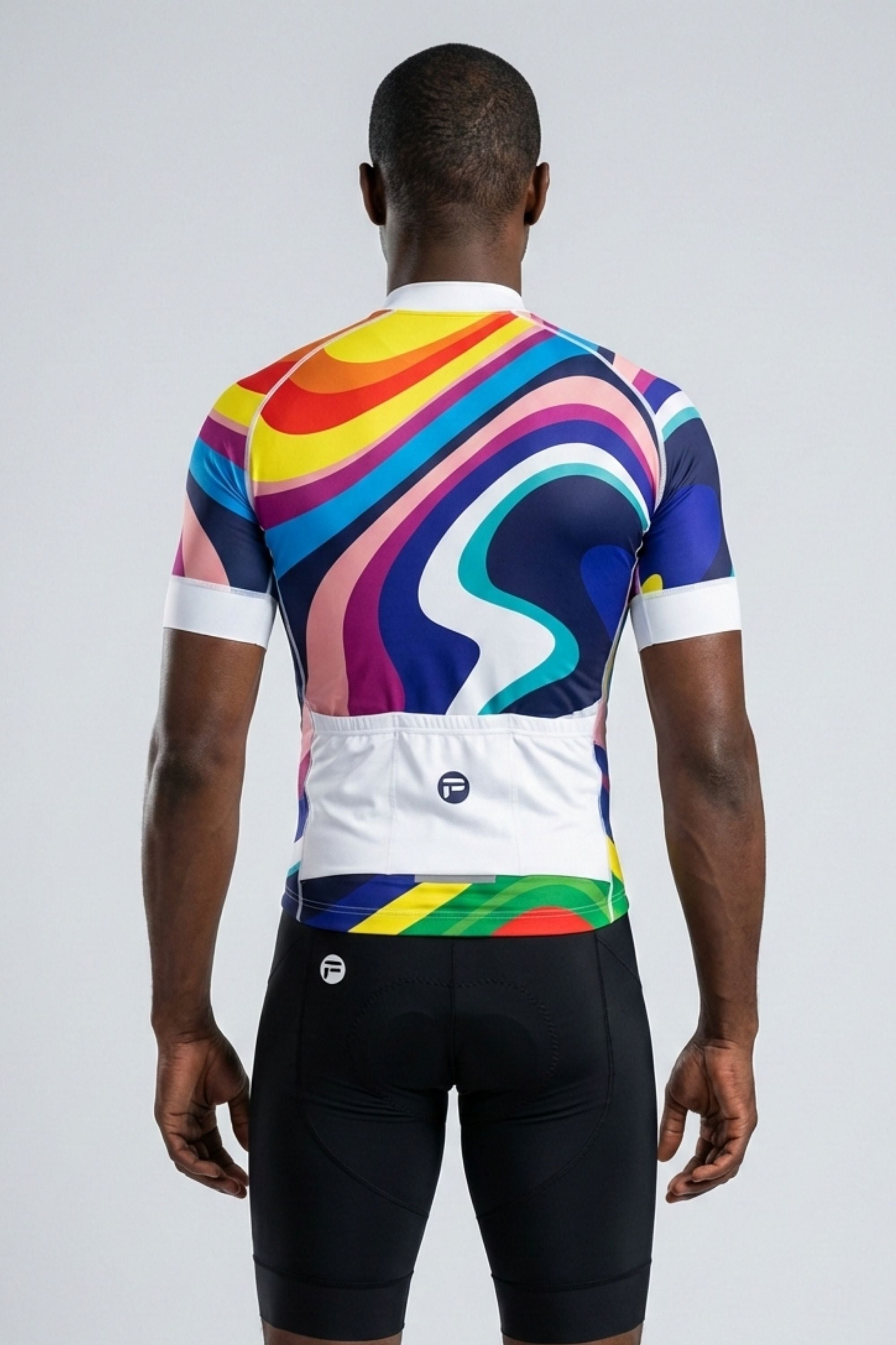 Person wearing a colorful cycling jersey and black shorts on a white background